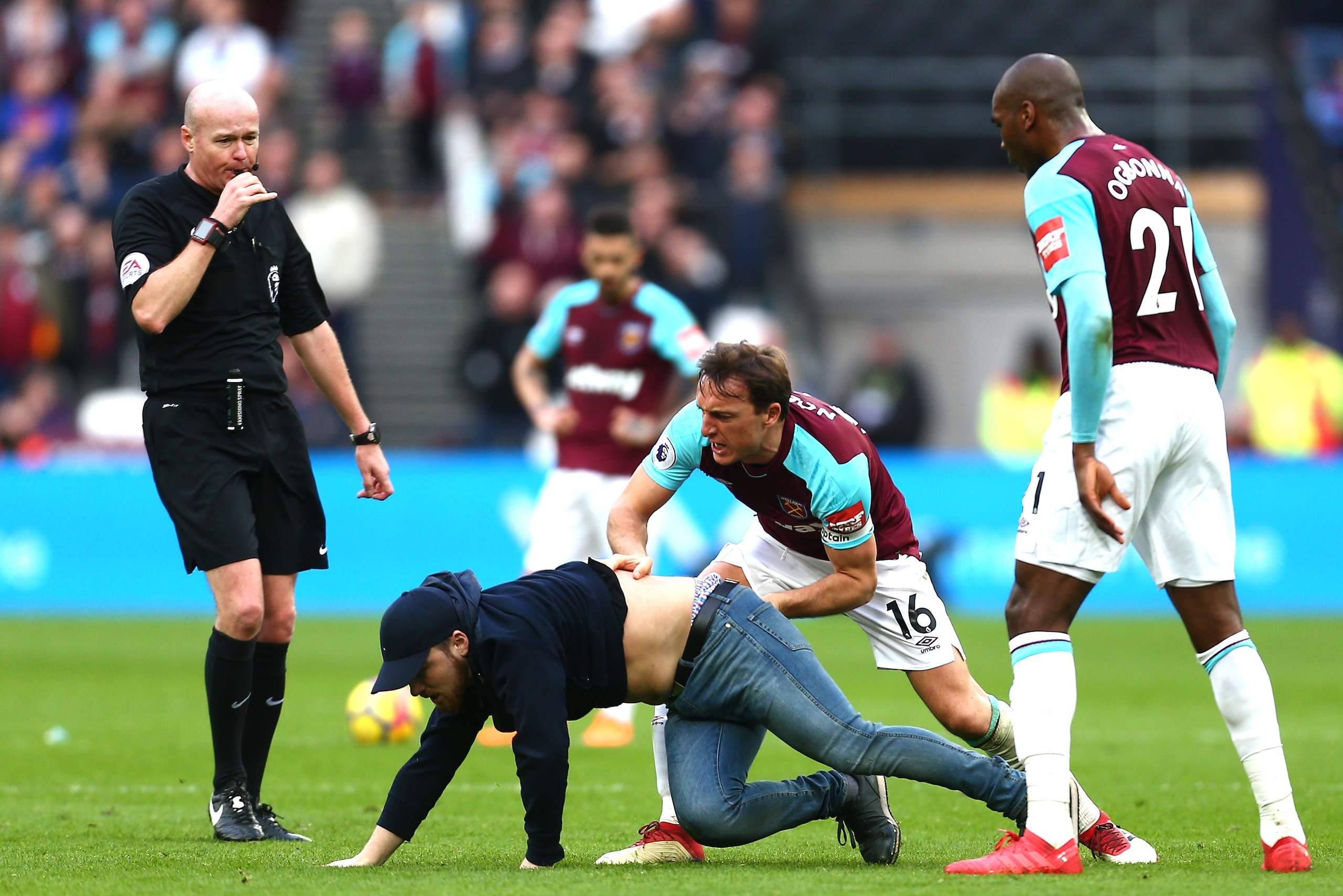 LONDON, ENGLAND - MARCH 10: Mark Noble of West Ham United clashes with a pitch invader during the Premier League match between West Ham United and Burnley at London Stadium on March 10, 2018 in London, England. (Photo by Jordan Mansfield/Getty Images) LONDON, ENGLAND - MARCH 10: Mark Noble of West Ham United clashes with a pitch invader during the Premier League match between West Ham United and Burnley at London Stadium on March 10, 2018 in London, England. (Photo by Jordan Mansfield/Getty Images)