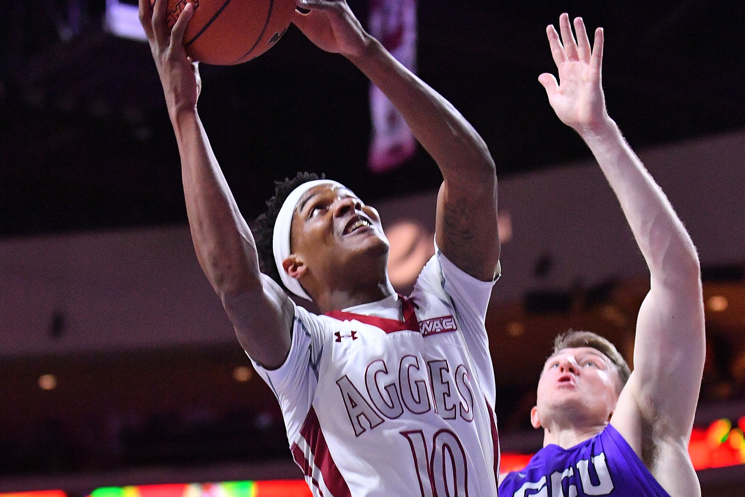 LAS VEGAS, NV - MARCH 10:  Jemerrio Jones #10 of the New Mexico State Aggies shoots against Joshua Braun #2 of the Grand Canyon Lopes during the championship game of the Western Athletic Conference basketball tournament at the Orleans Arena on March 10, 2