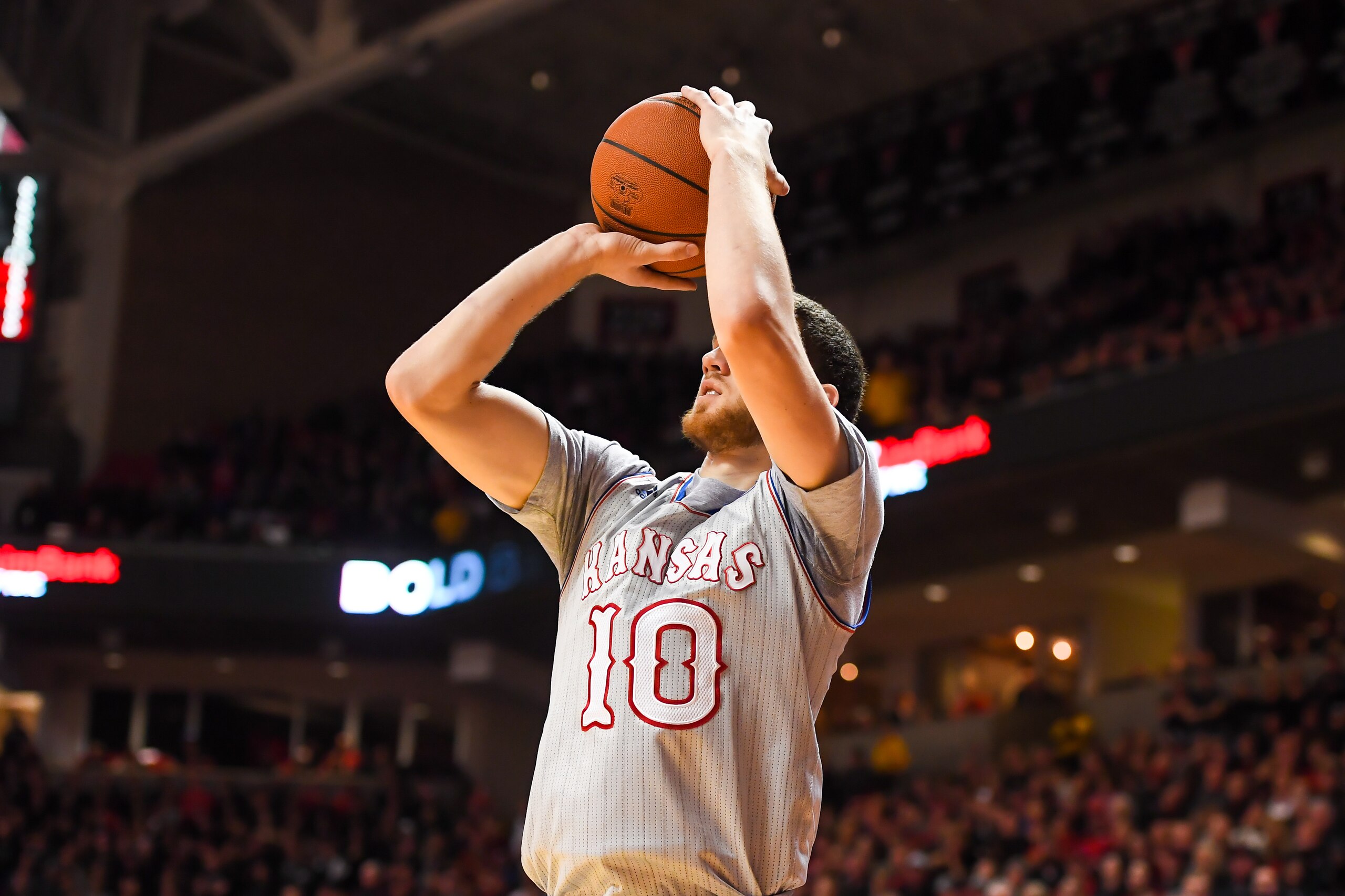 LUBBOCK, TX - FEBRUARY 24: Sviatoslav Mykhailiuk #10 of the Kansas Jayhawks shoots the ball from the corner during the game against the Texas Tech Red Raiders on February 24, 2018 at United Supermarket Arena in Lubbock, Texas. Kansas defeated Texas Tech 7 LUBBOCK, TX - FEBRUARY 24: Sviatoslav Mykhailiuk #10 of the Kansas Jayhawks shoots the ball from the corner during the game against the Texas Tech Red Raiders on February 24, 2018 at United Supermarket Arena in Lubbock, Texas. Kansas defeated Texas Tech 7