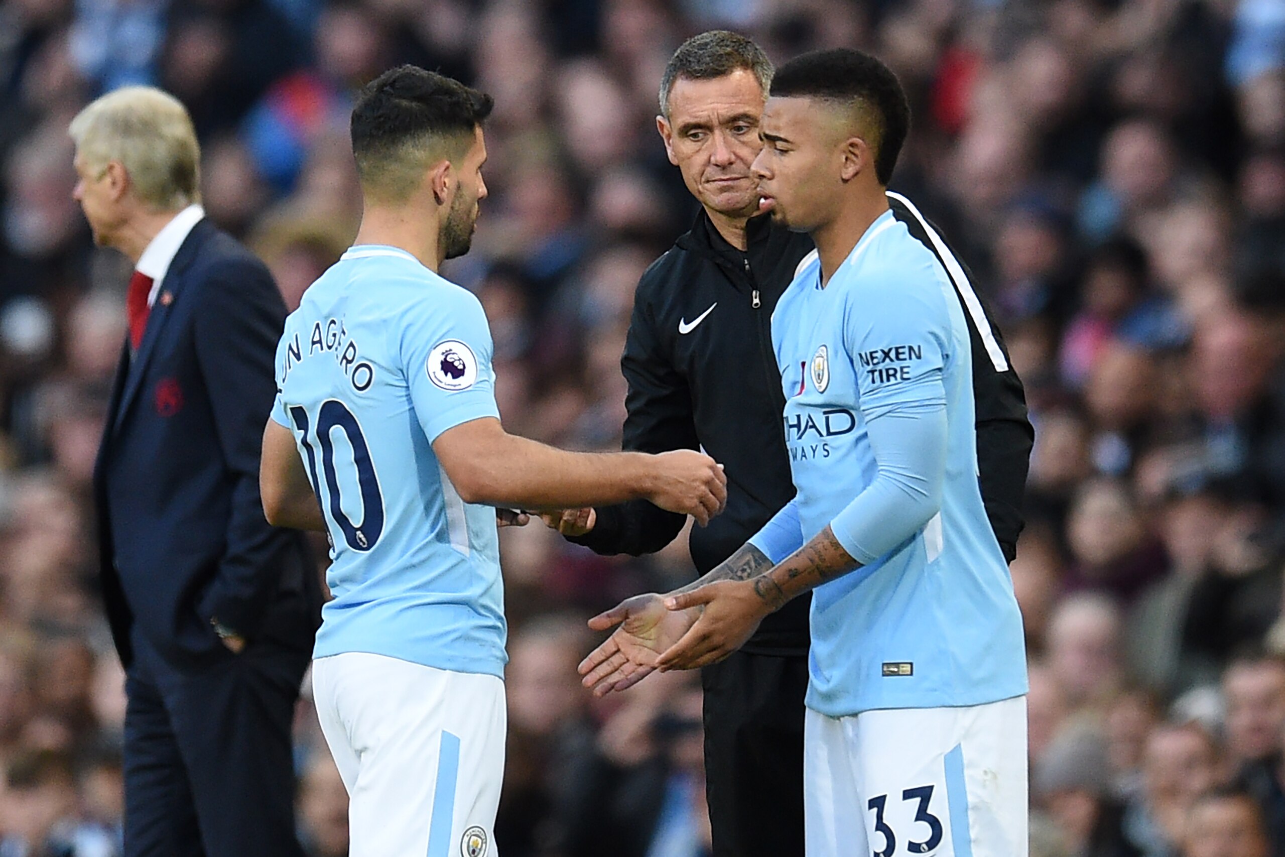 Manchester City's Argentinian striker Sergio Aguero (L) is substituted for Manchester City's Brazilian striker Gabriel Jesus during the English Premier League football match between Manchester City and Arsenal at the Etihad Stadium in Manchester, north we