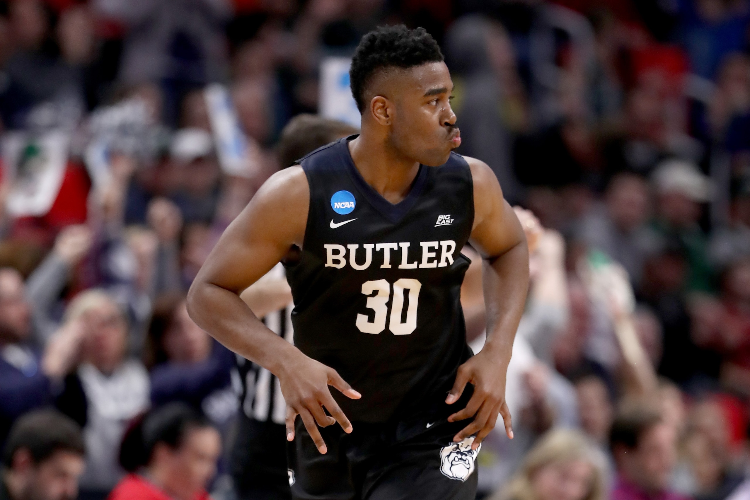 DETROIT, MI - MARCH 16:  Kelan Martin #30 of the Butler Bulldogs reacts after a three point basket against the Arkansas Razorbacks during the second half of the game in the first round of the 2018 NCAA Men's Basketball Tournament at Little Caesars Arena o