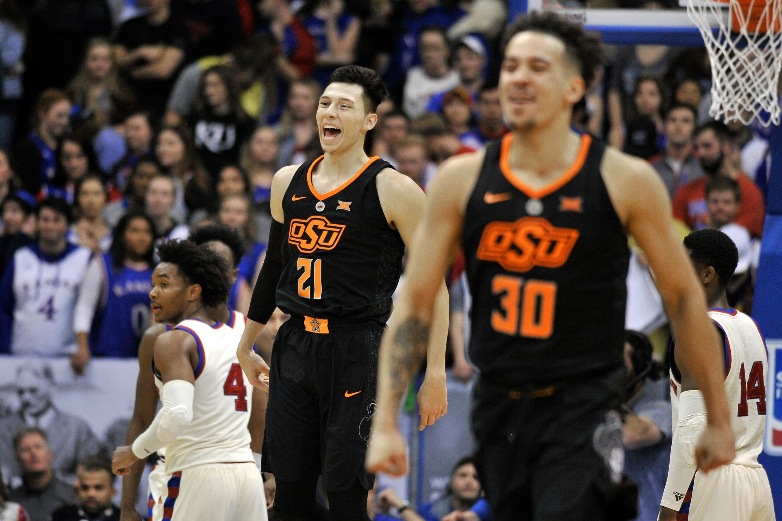 LAWRENCE, KS - FEBRUARY 3: Lindy Waters III #21 and Jeffrey Carroll #30 of the Oklahoma State Cowboys celebrate a 84-79 win over Kansas Jayhawks at Allen Fieldhouse on February 3, 2018 in Lawrence, Kansas. (Photo by Ed Zurga/Getty Images)