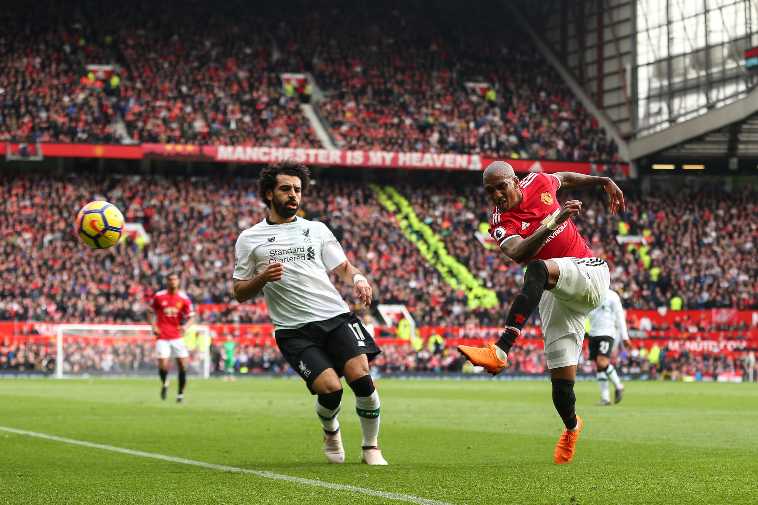 MANCHESTER, ENGLAND - MARCH 10: Mohamed Salah of Liverpool and Ashley Young of Manchester United during the Premier League match between Manchester United and Liverpool at Old Trafford on March 10, 2018 in Manchester, England. (Photo by Robbie Jay Barratt