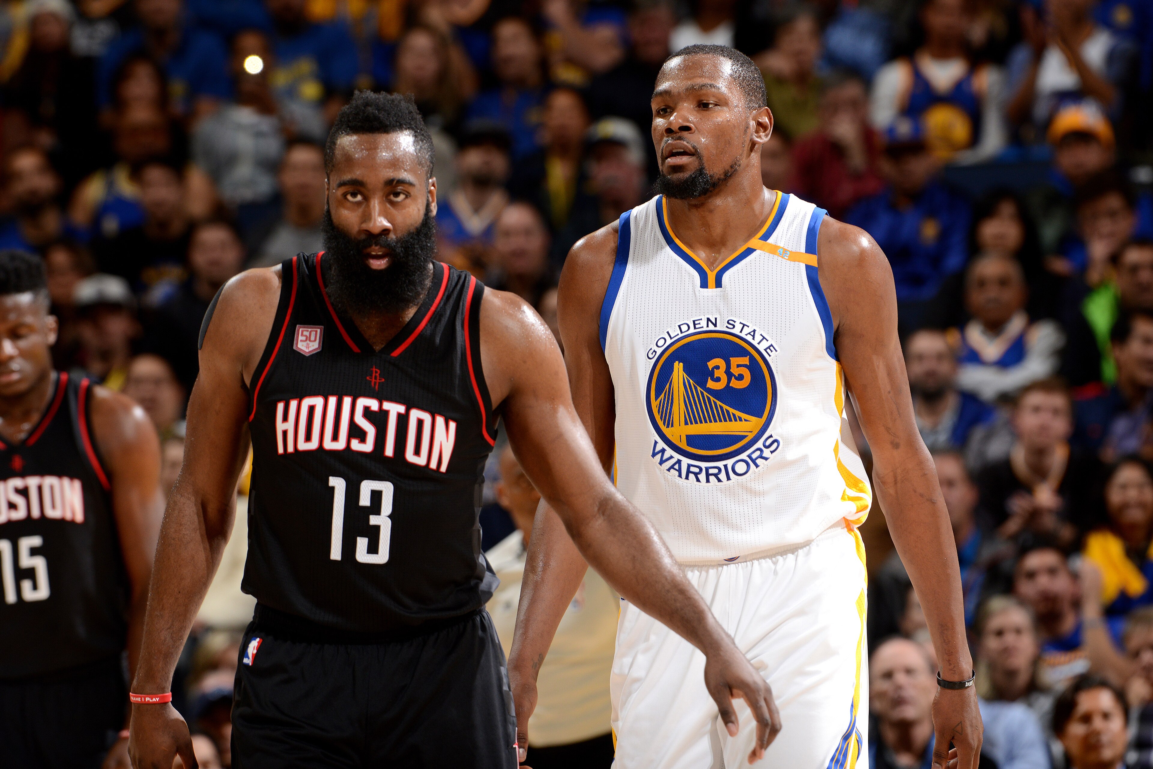 OAKLAND, CA - DECEMBER 1: James Harden #13 of the Houston Rockets and Kevin Durant #35 of the Golden State Warriors look on during the game on December 1, 2016 at ORACLE Arena in Oakland, California. NOTE TO USER: User expressly acknowledges and agrees th