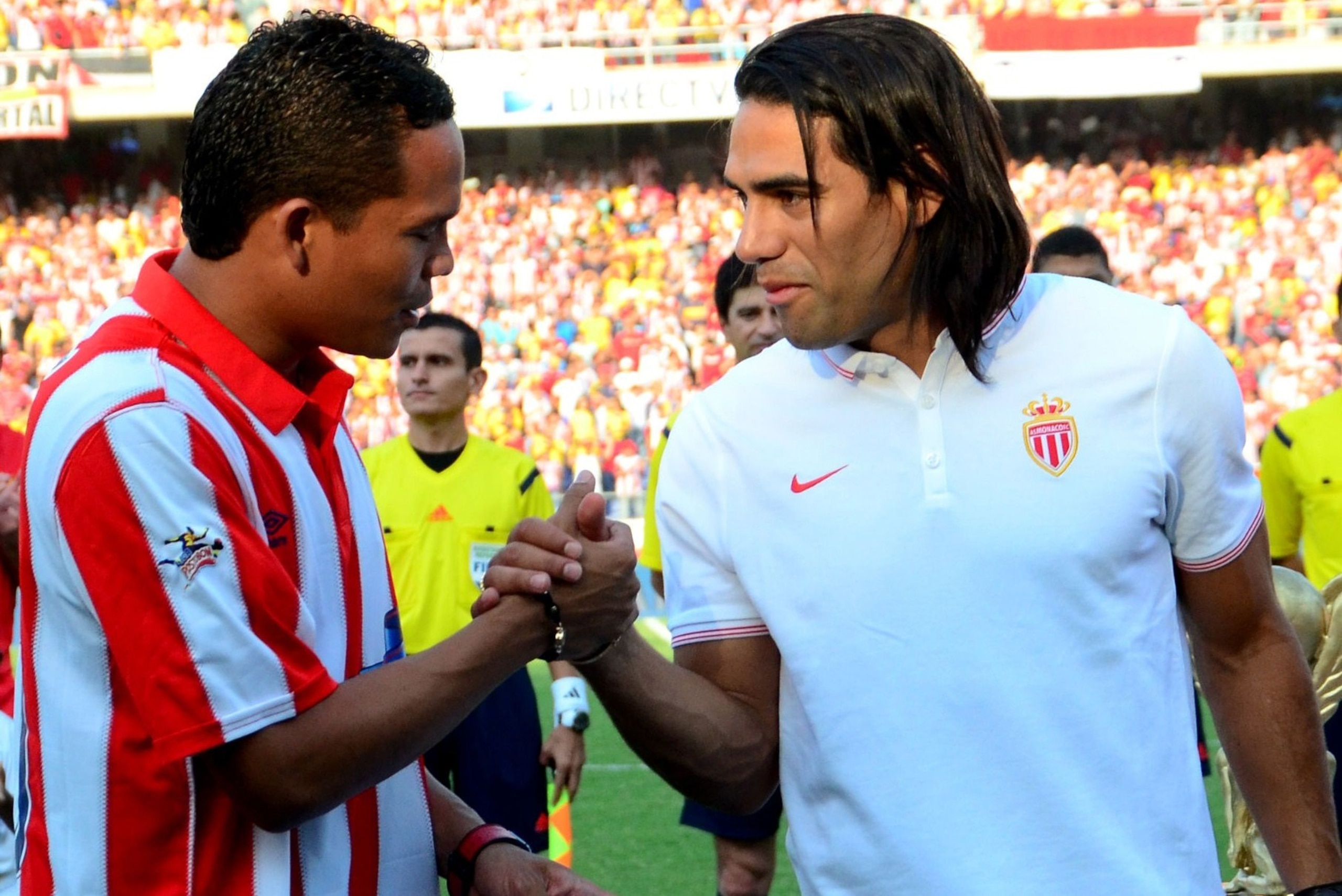 Monaco's Colombian forward Radamel Falcao (R) shakes hands with Colombian player Carlos Bacca before the start of the EuroAmerican Cup football match between AS Monaco and Junior de Barranquilla at the Roberto Melendez Metropolitano Stadium in Barranquill
