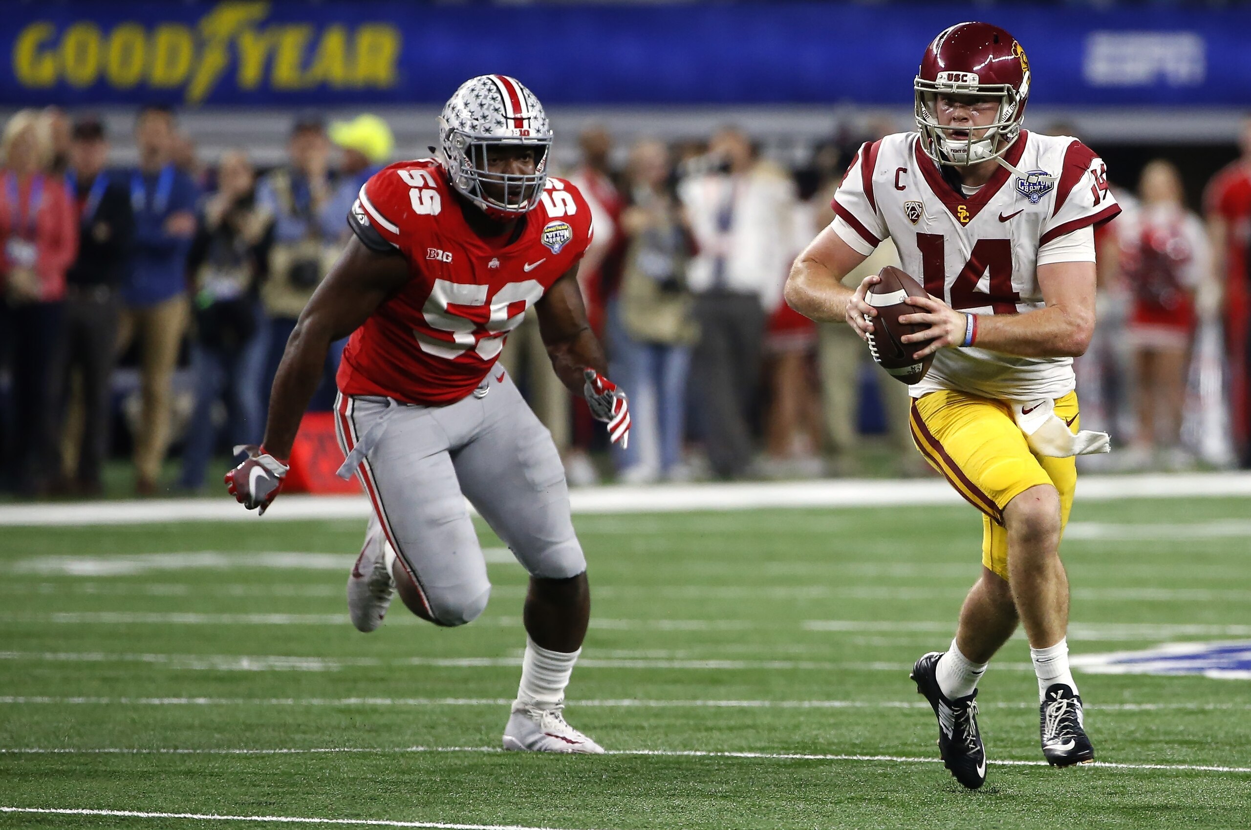 ARLINGTON, TX - DECEMBER 29: Sam Darnold #14 of the USC Trojans runs from Tyquan Lewis #59 of the Ohio State Buckeyes in the second half of the 82nd Goodyear Cotton Bowl Classic between USC and Ohio State at AT&T Stadium on December 29, 2017 in Arlington,