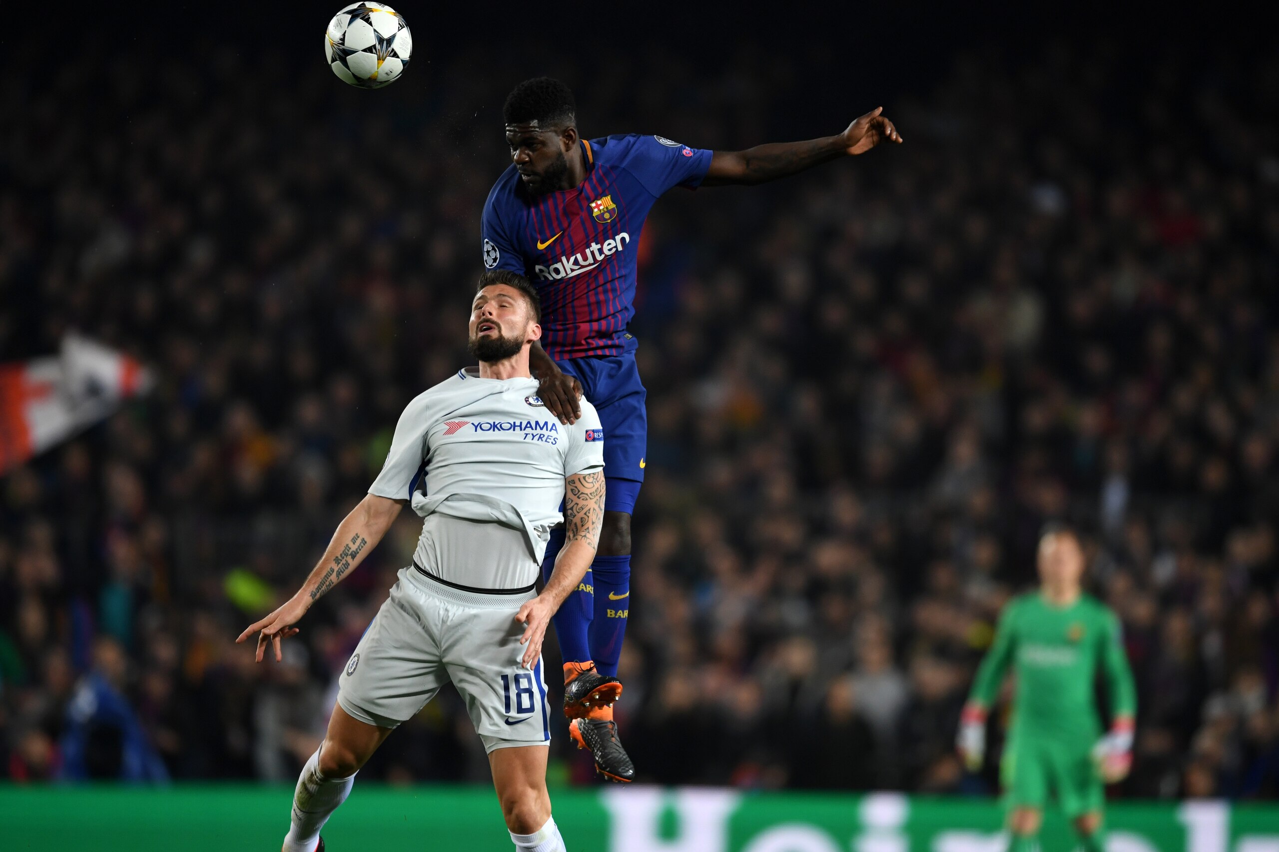 BARCELONA, SPAIN - MARCH 14: Olivier Giroud of Chelsea and Samuel Umtiti of Barcelona compete for the ball during the UEFA Champions League Round of 16 Second Leg match FC Barcelona and Chelsea FC at Camp Nou on March 14, 2018 in Barcelona, Spain. (Photo 