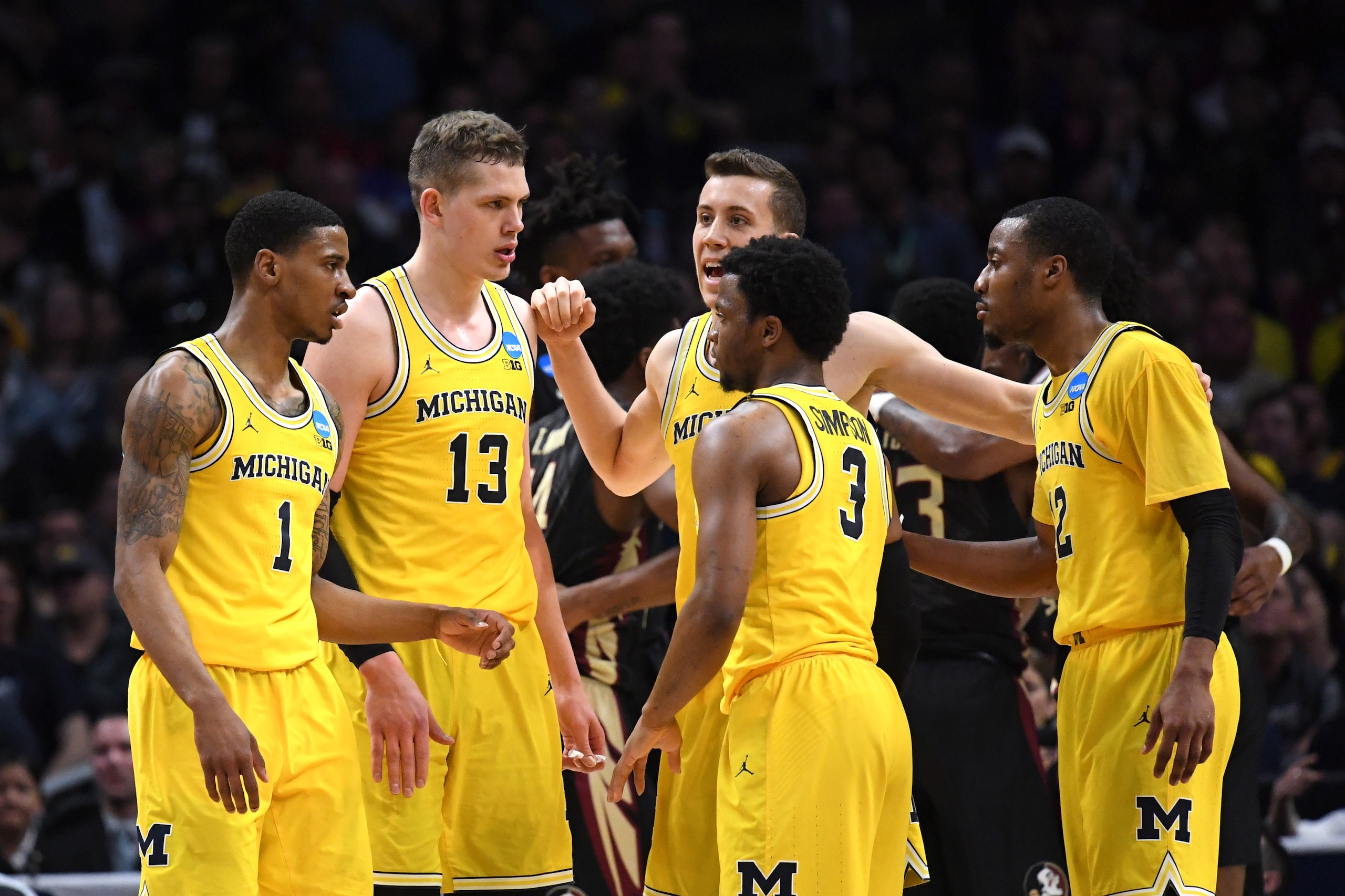 LOS ANGELES, CA - MARCH 24: Charles Matthews #1, Moritz Wagner #13, Duncan Robinson #22, Zavier Simpson #3 and Muhammad-Ali Abdur-Rahkman #12 of the Michigan Wolverines huddle against the Florida State Seminoles during the first half in the 2018 NCAA Men'