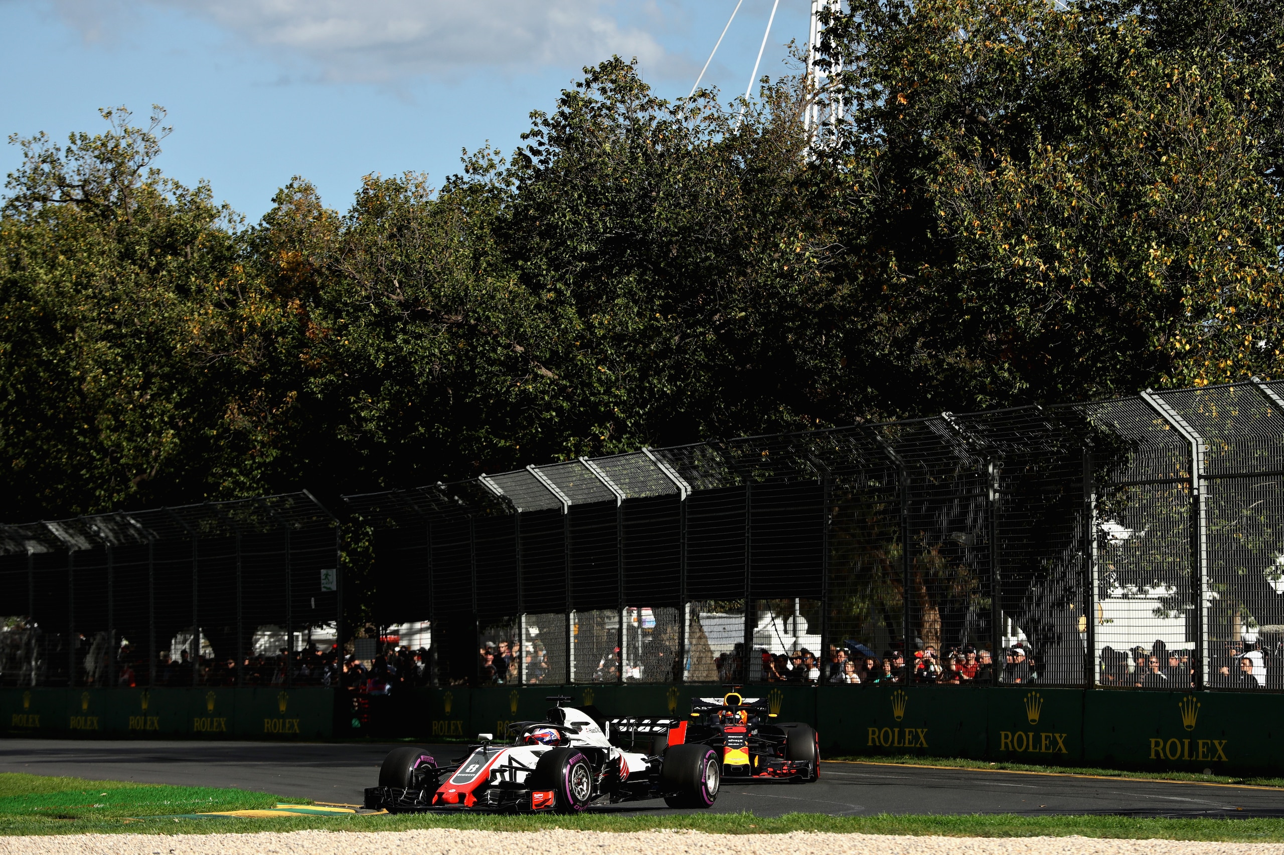 MELBOURNE, AUSTRALIA - MARCH 25: Romain Grosjean of France driving the (8) Haas F1 Team VF-18 Ferrari leads Daniel Ricciardo of Australia driving the (3) Aston Martin Red Bull Racing RB14 TAG Heuer on track during the Australian Formula One Grand Prix at 