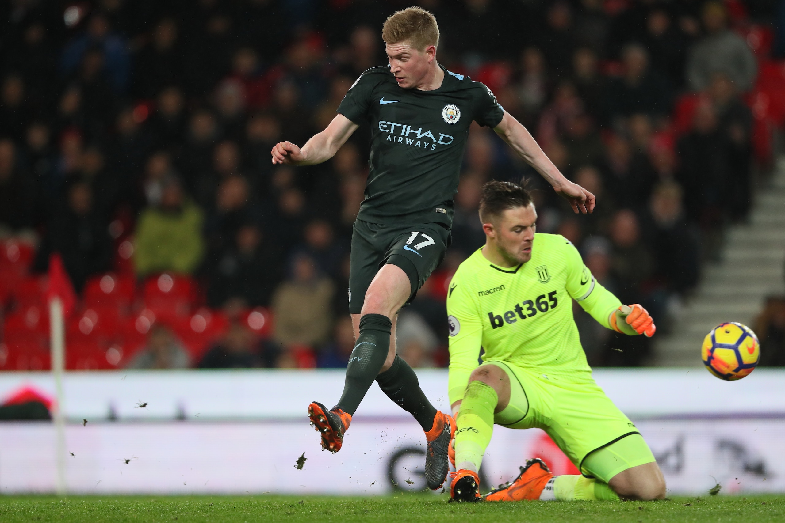 STOKE ON TRENT, ENGLAND - MARCH 12: Kevin De Bruyne of Manchester City and Jack Butland of Stoke City during the Premier League match between Stoke City and Manchester City at Bet365 Stadium on March 12, 2018 in Stoke on Trent, England. (Photo by Matthew 