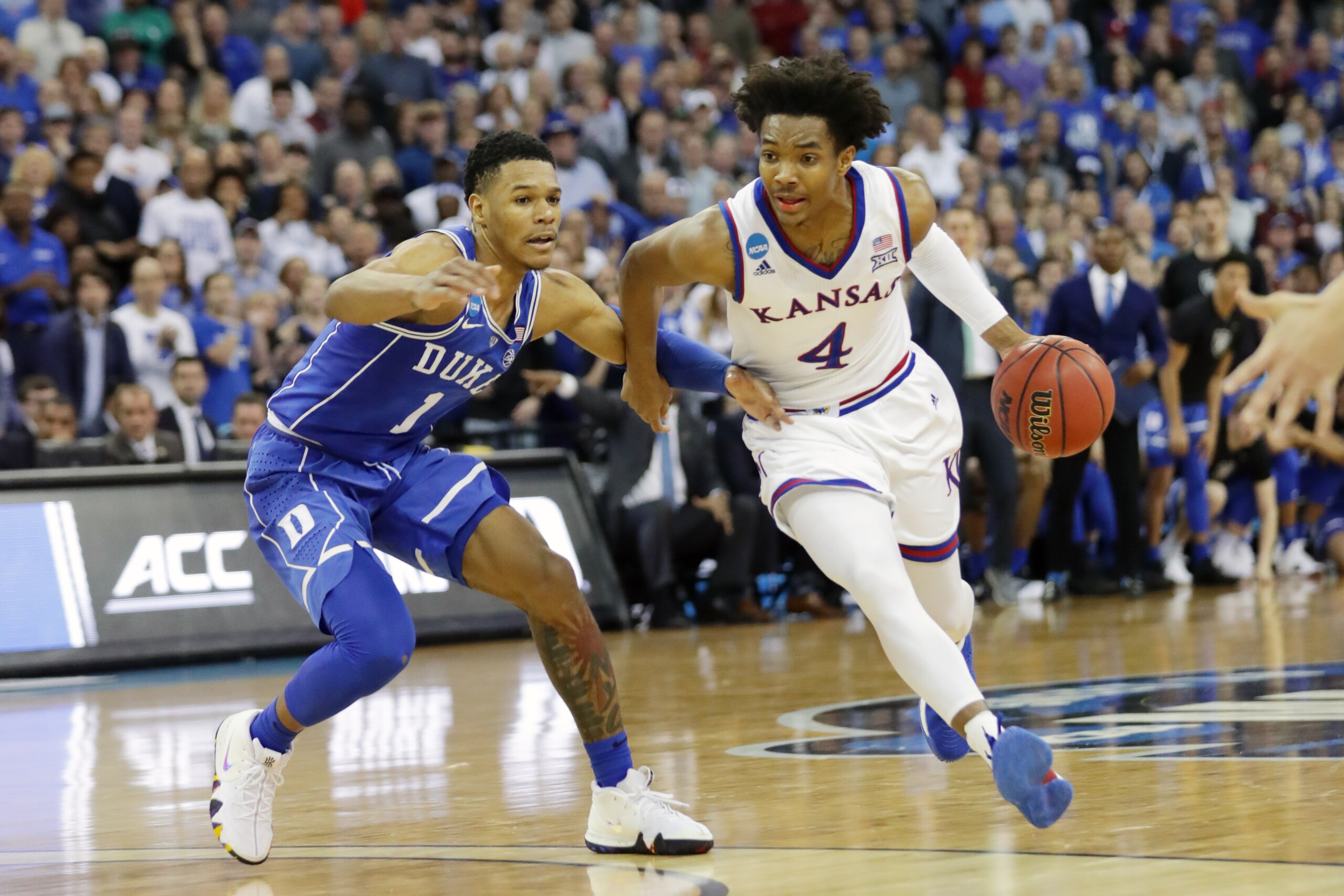 OMAHA, NE - MARCH 25: Devonte' Graham #4 of the Kansas Jayhawks is defended by Trevon Duval #1 of the Duke Blue Devils during the second half in the 2018 NCAA Men's Basketball Tournament Midwest Regional at CenturyLink Center on March 25, 2018 in Omaha, N