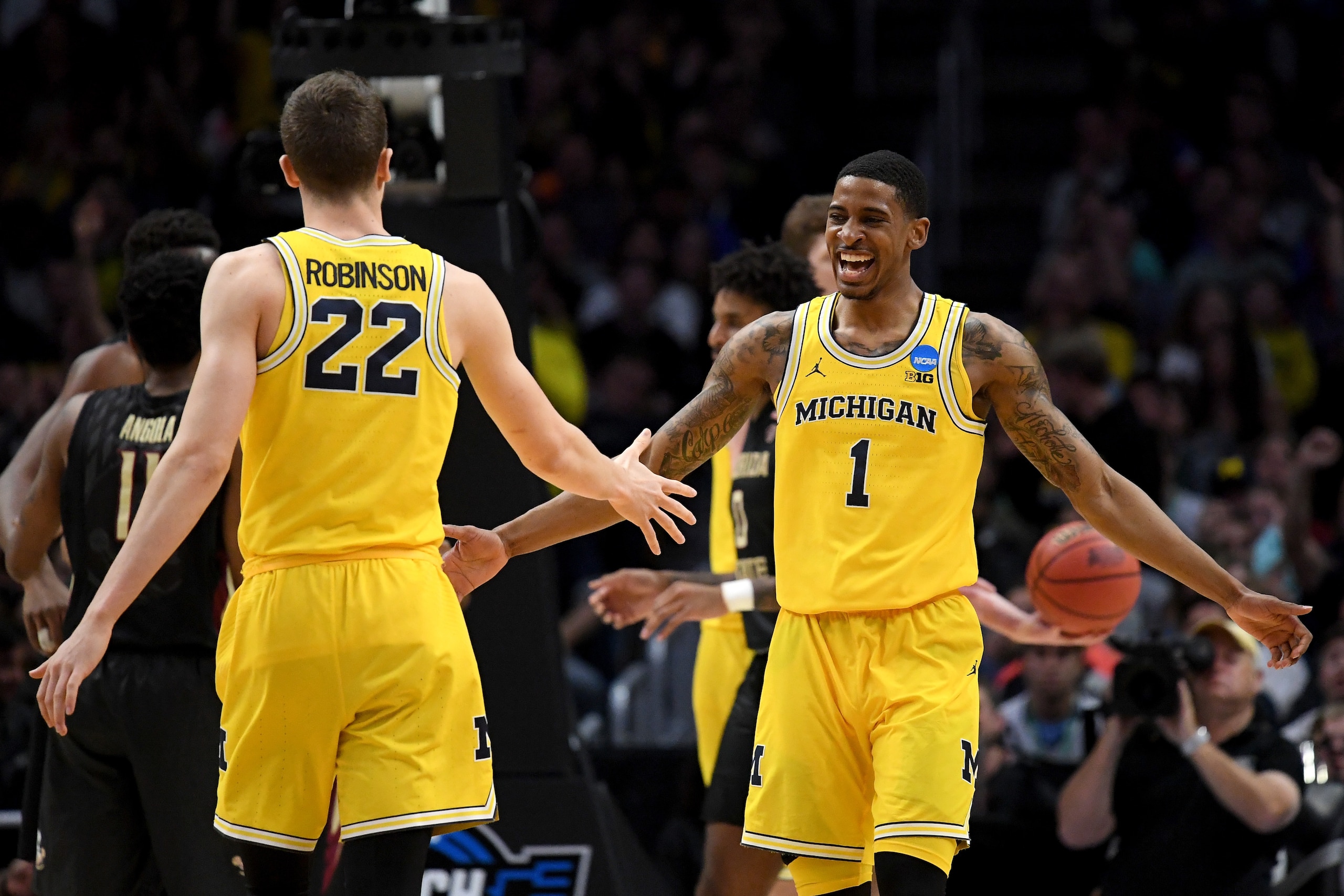 LOS ANGELES, CA - MARCH 24:  Charles Matthews #1 celebrates with teammate Duncan Robinson #22 of the Michigan Wolverines in the first half against the Florida State Seminoles in the 2018 NCAA Men's Basketball Tournament West Regional Final at Staples Cent