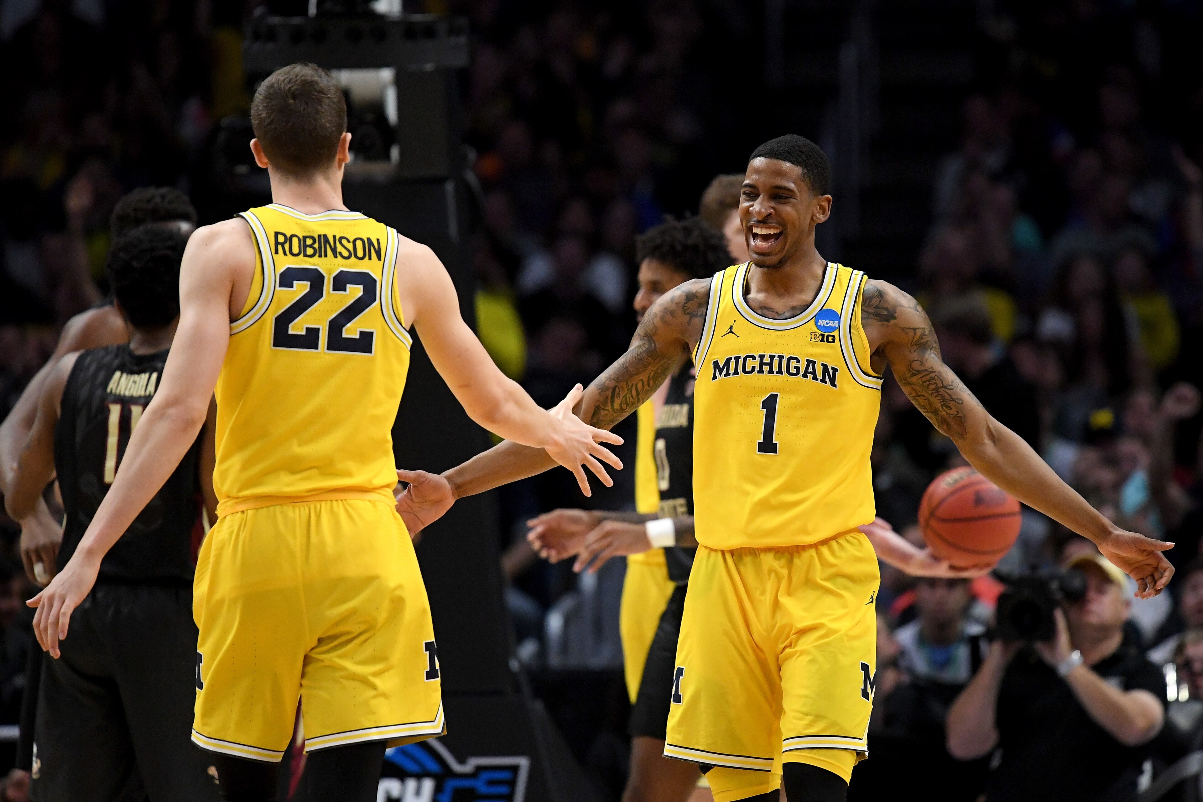 LOS ANGELES, CA - MARCH 24:  Charles Matthews #1 celebrates with teammate Duncan Robinson #22 of the Michigan Wolverines in the first half against the Florida State Seminoles in the 2018 NCAA Men's Basketball Tournament West Regional Final at Staples Cent