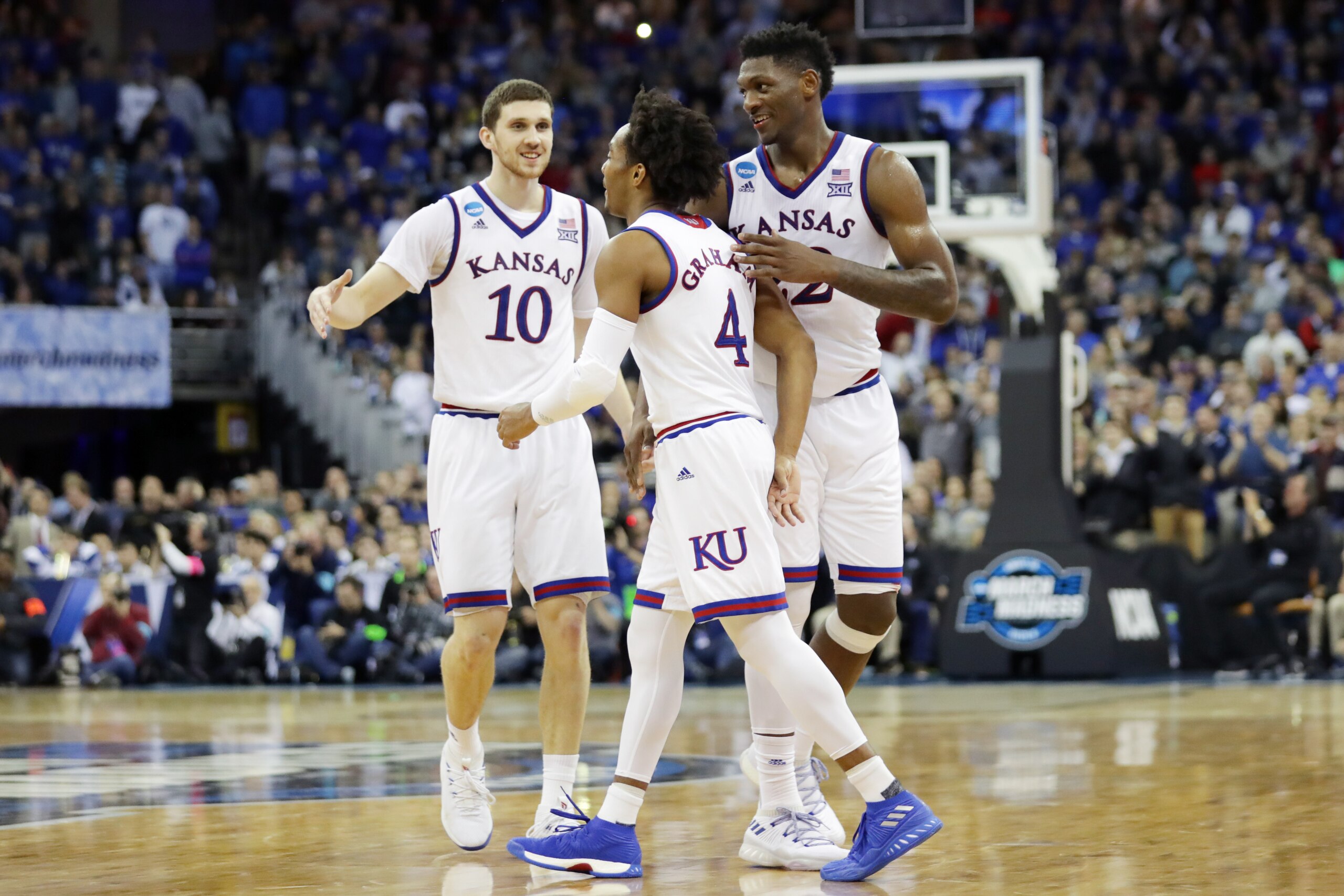 OMAHA, NE - MARCH 25:  Silvio De Sousa #22, Devonte' Graham #4 and Sviatoslav Mykhailiuk #10 of the Kansas Jayhawks celebrate as they defeat the Duke Blue Devils in the 2018 NCAA Men's Basketball Tournament Midwest Regional at CenturyLink Center on March 