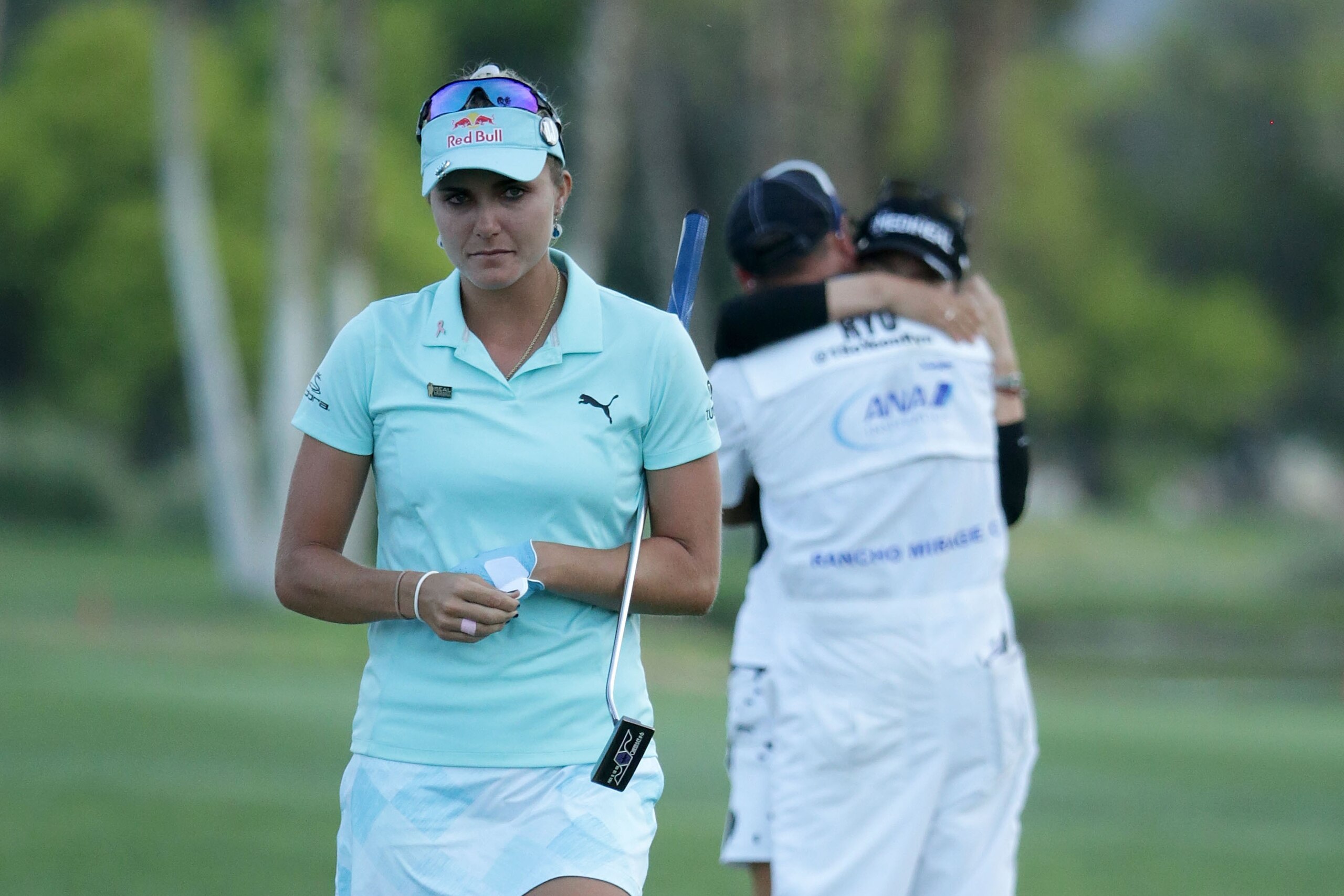 RANCHO MIRAGE, CA - APRIL 02:  Lexi Thompson (L) walks off the 18th green, as So Yeon Ryu of the Republic of Korea celebrates with her caddie after Ryu defeated Thompson in a playoff during the final round of the ANA Inspiration at the Dinah Shore Tournam