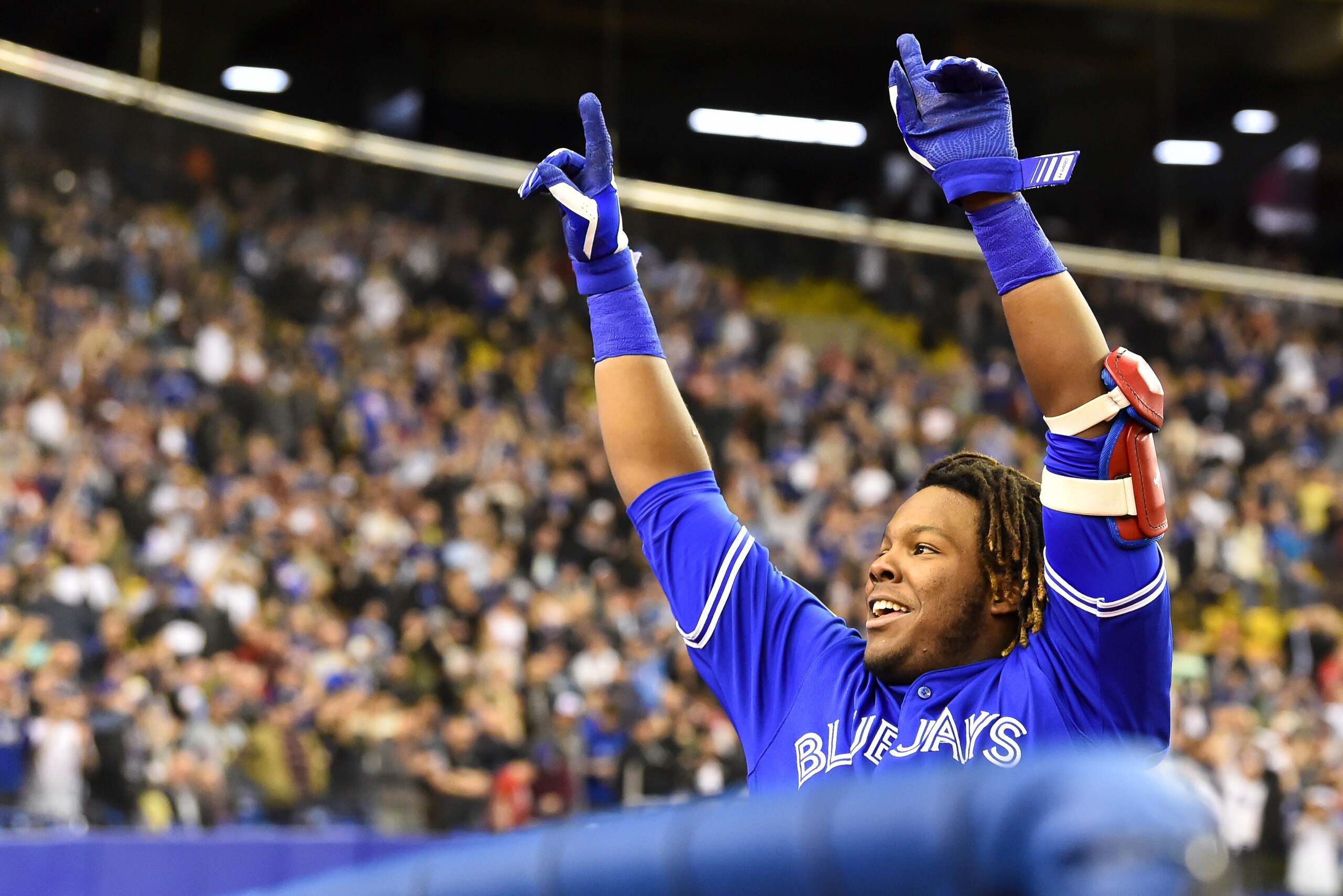 MONTREAL, QC - MARCH 27:  Vladimir Guerrero Jr. #27 of the Toronto Blue Jays acknowledges the fans after hitting a home run in the bottom of the ninth against the St. Louis Cardinals during the MLB preseason game at Olympic Stadium on March 27, 2018 in Mo