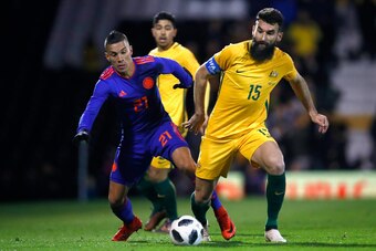 LONDON, ENGLAND - MARCH 27: Mateus Uribe of Columbia competes for the ball with Mile Jedinak of Australia during the International friendly between Australia and Colombia at Craven Cottage on March 27, 2018 in London, England.  (Photo by Julian Finney/Get