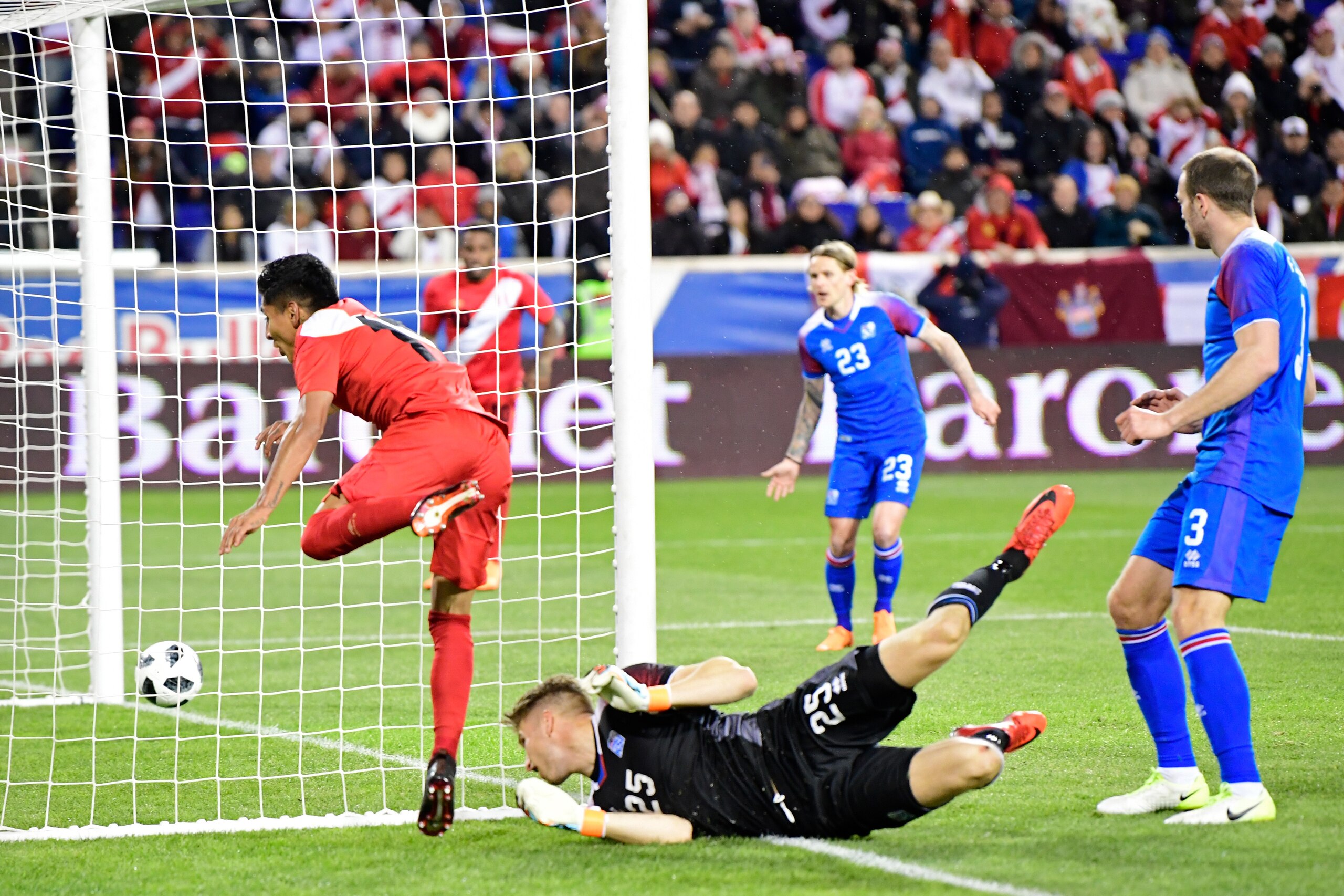 HARRISON, NJ - MARCH 27:  Raul Ruidiaz #11 of Peru scores a second half goal past Frederik Schram #25 of Iceland in an International Friendly match at Red Bull Arena on March 27, 2018 in Harrison, New Jersey.  (Photo by Steven Ryan/Getty Images)