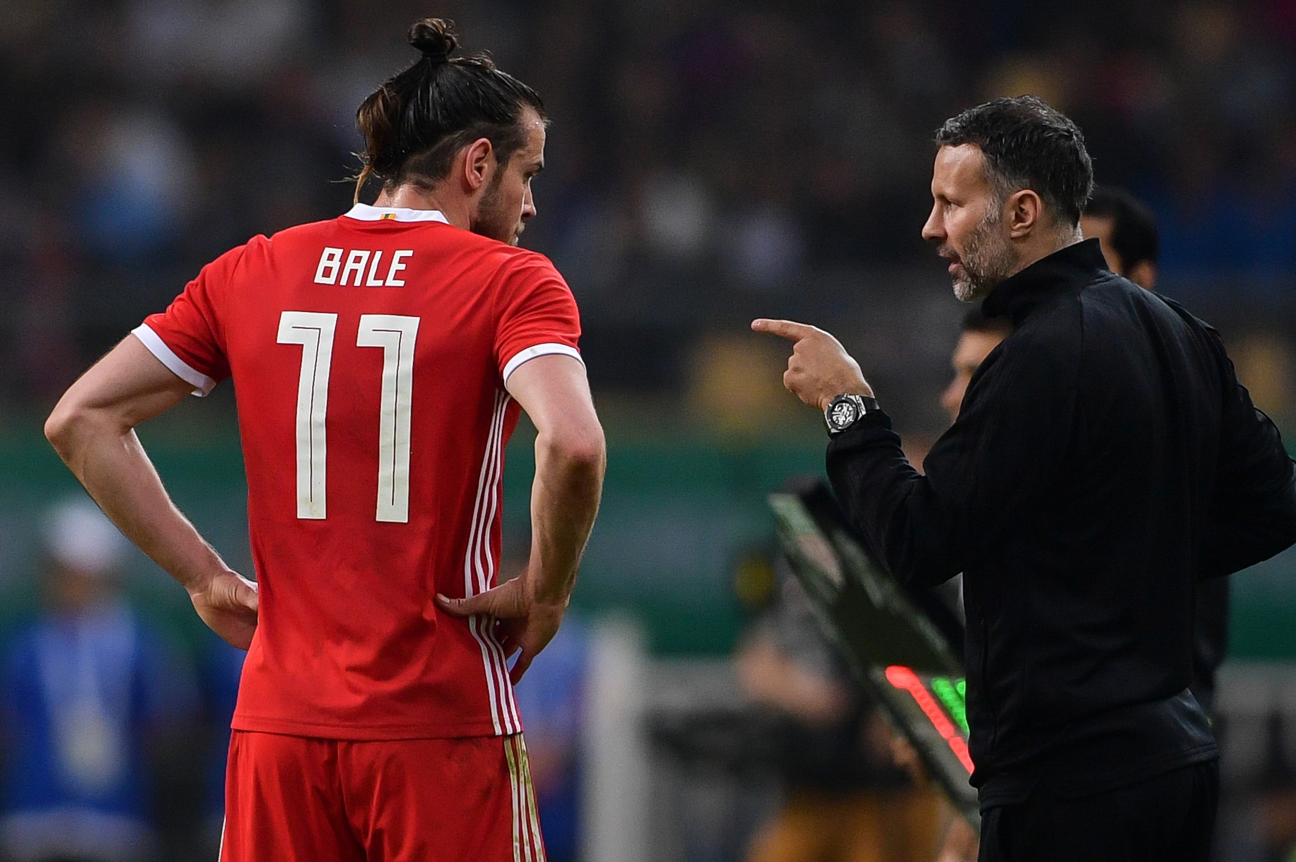 Wales' head coach Ryan Giggs (R) talks with Wales' Gareth Bale during their China Cup International Football Championship final match against Uruguay in Nanning in China's southern Guangxi region on March 26, 2018. / AFP PHOTO / - / China OUT (Phot Wales' head coach Ryan Giggs (R) talks with Wales' Gareth Bale during their China Cup International Football Championship final match against Uruguay in Nanning in China's southern Guangxi region on March 26, 2018. / AFP PHOTO / - / China OUT (Phot