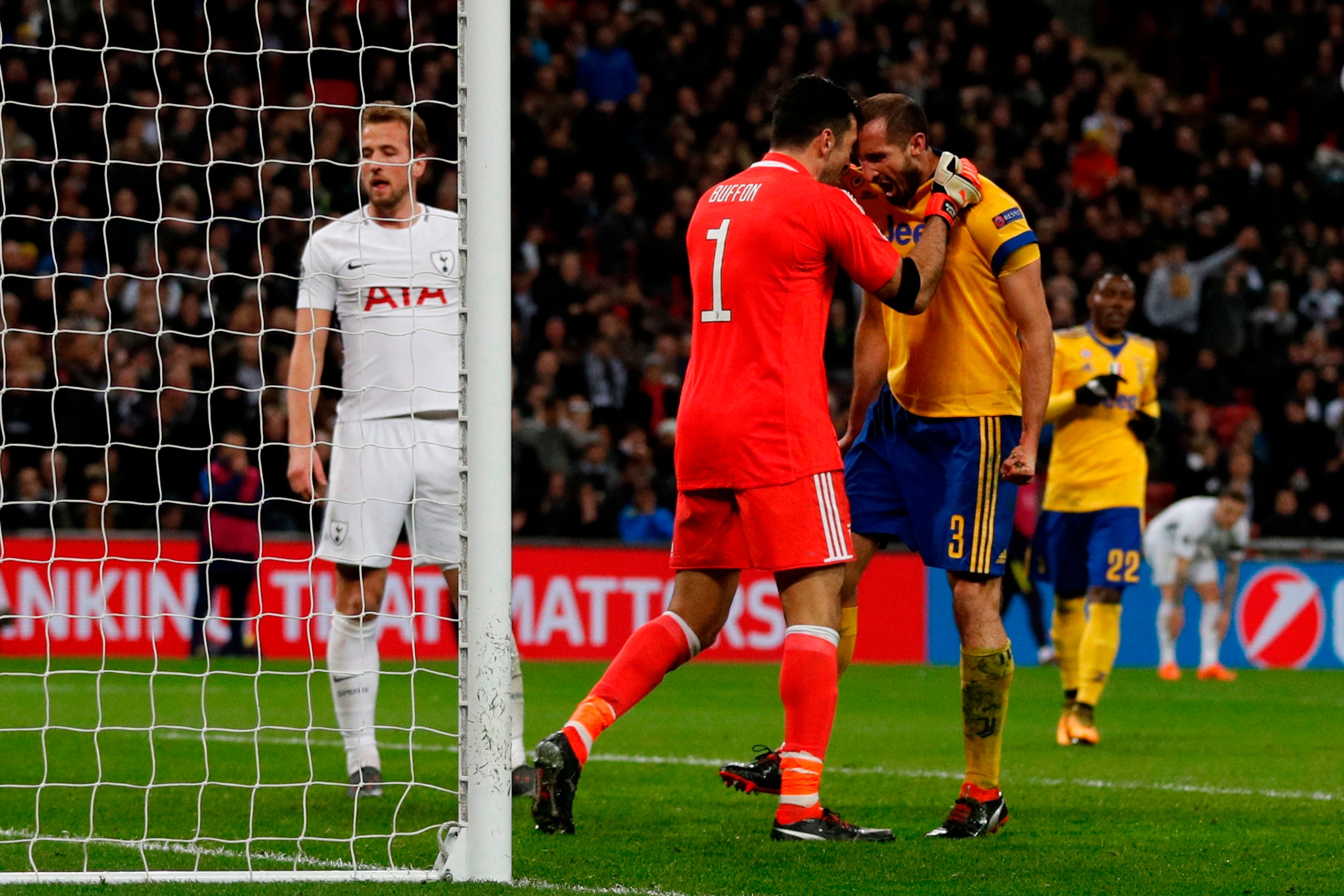 TOPSHOT - Juventus' Italian defender Giorgio Chiellini (R) reacts with Juventus' Italian goalkeeper Gianluigi Buffon (L) after making an interception during the UEFA Champions League round of sixteen second leg football match between Tottenham Hotspur and
