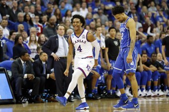 OMAHA, NE - MARCH 25: Gary Trent Jr. #2 of the Duke Blue Devils reacts as Devonte' Graham #4 of the Kansas Jayhawks celebrates after his team defeated the Duke Blue Devils in the 2018 NCAA Men's Basketball Tournament Midwest Regional at CenturyLink Center