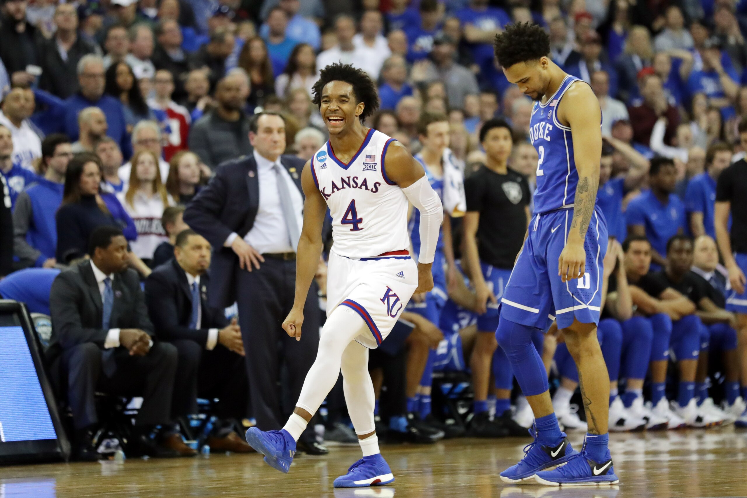 OMAHA, NE - MARCH 25: Gary Trent Jr. #2 of the Duke Blue Devils reacts as Devonte' Graham #4 of the Kansas Jayhawks celebrates after his team defeated the Duke Blue Devils in the 2018 NCAA Men's Basketball Tournament Midwest Regional at CenturyLink Center