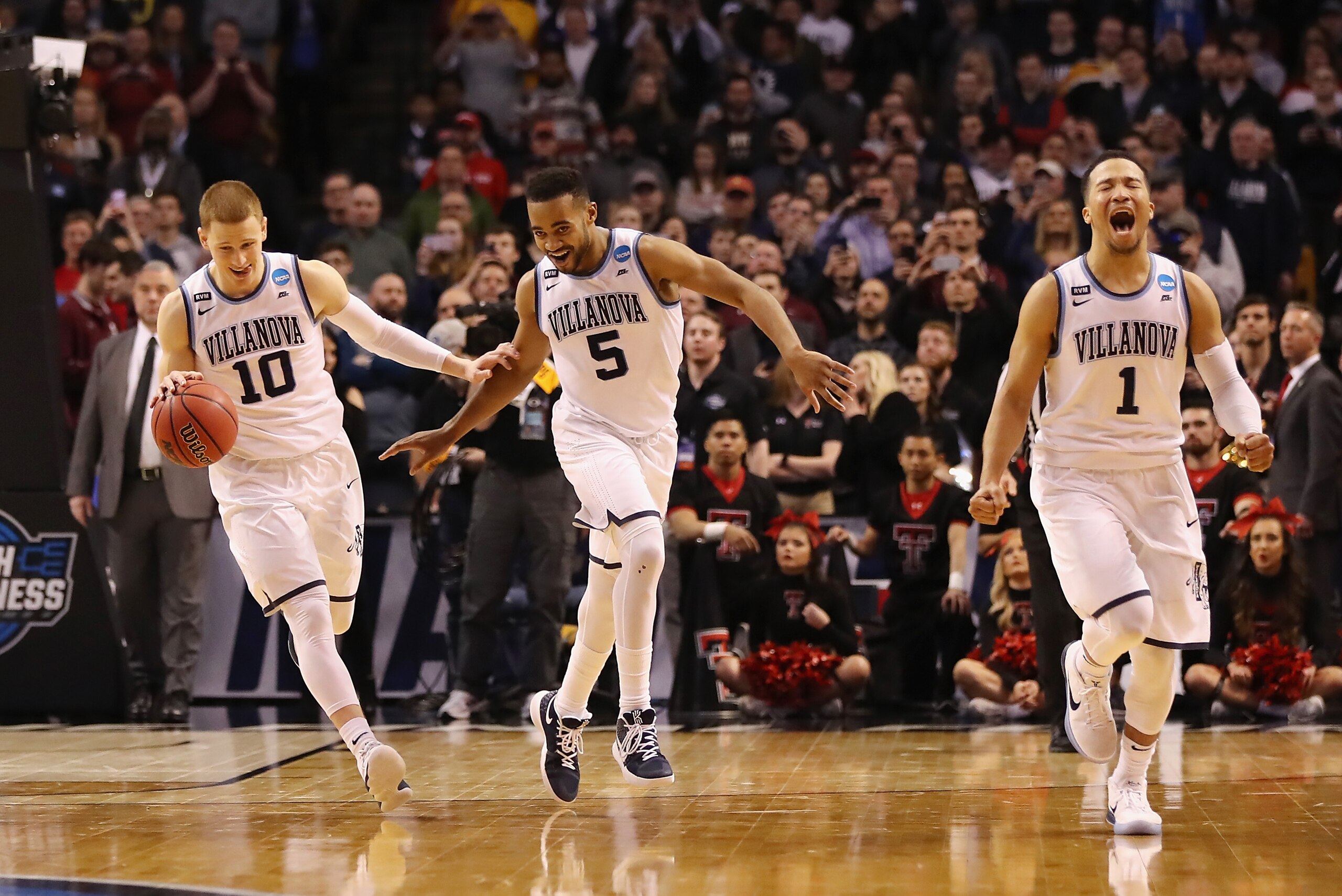 BOSTON, MA - MARCH 25:  Donte DiVincenzo #10, Phil Booth #5, and Jalen Brunson #1 of the Villanova Wildcats celebrate defeating the Texas Tech Red Raiders 71-59 in the 2018 NCAA Men's Basketball Tournament East Regional to advance to the 2018 Final Four a