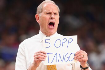 SAN ANTONIO, TX - MARCH 31: Head coach John Beilein of the Michigan Wolverines holds up a sign in the first half against the Loyola Ramblers during the 2018 NCAA Men's Final Four Semifinal at the Alamodome on March 31, 2018 in San Antonio, Texas.  (Photo 