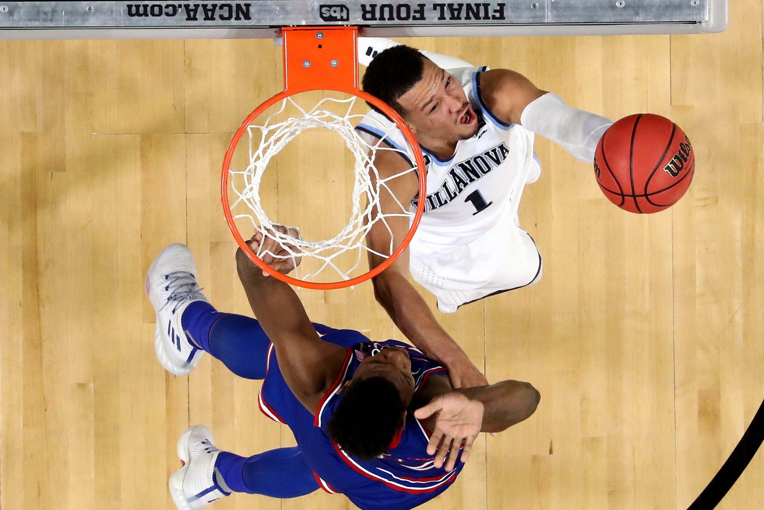 SAN ANTONIO, TX - MARCH 31: Jalen Brunson #1 of the Villanova Wildcats drives to the basket against Silvio De Sousa #22 of the Kansas Jayhawks during the 2018 NCAA Men's Final Four Semifinal at the Alamodome on March 31, 2018 in San Antonio, Texas.  (Phot