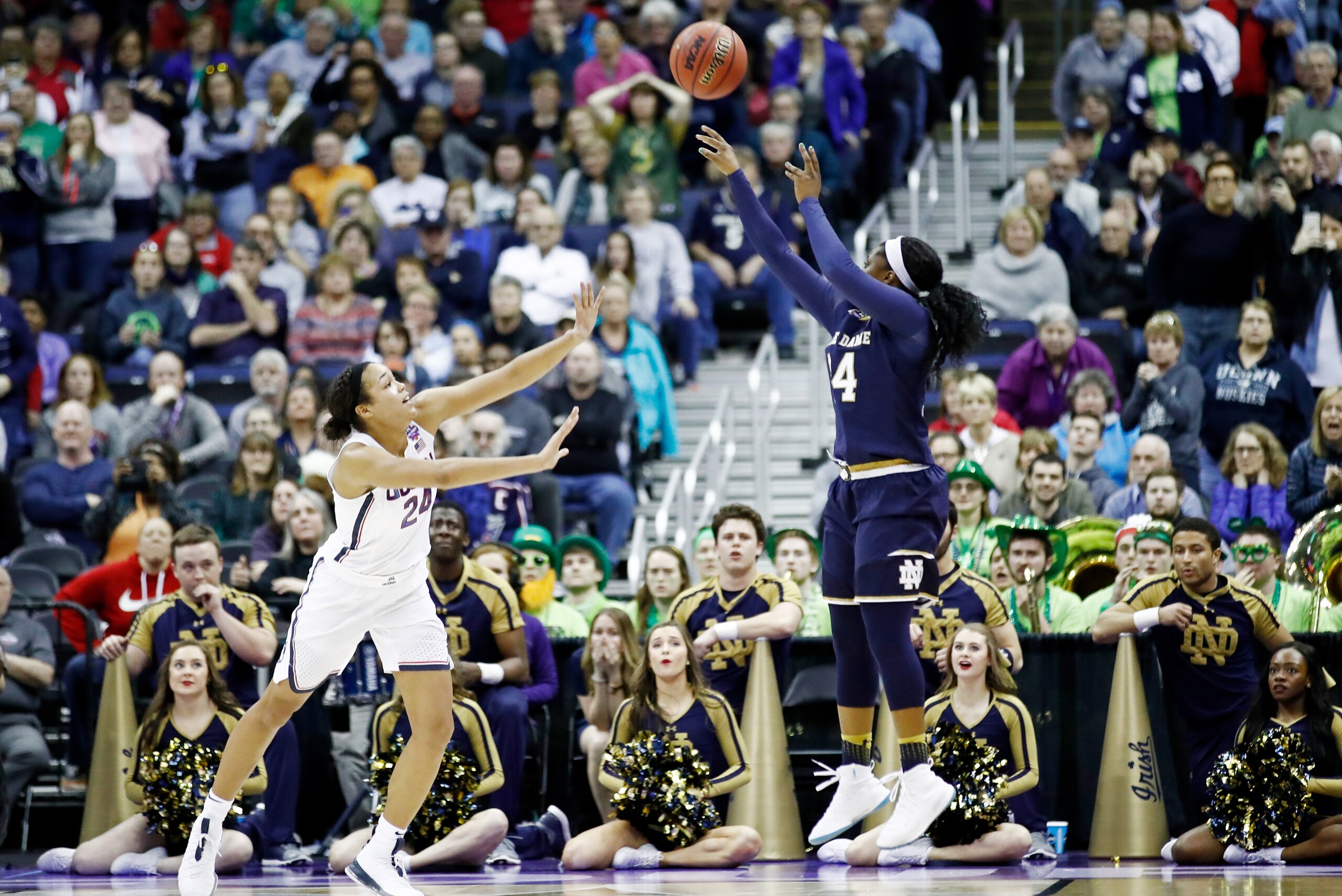 COLUMBUS, OH - MARCH 30: Arike Ogunbowale #24 of the Notre Dame Fighting Irish hits the game winning shot with 1 second left in overtime under pressure from Napheesa Collier #24 of the Connecticut Huskies in the semifinals of the 2018 NCAA Women's Final F COLUMBUS, OH - MARCH 30: Arike Ogunbowale #24 of the Notre Dame Fighting Irish hits the game winning shot with 1 second left in overtime under pressure from Napheesa Collier #24 of the Connecticut Huskies in the semifinals of the 2018 NCAA Women's Final F