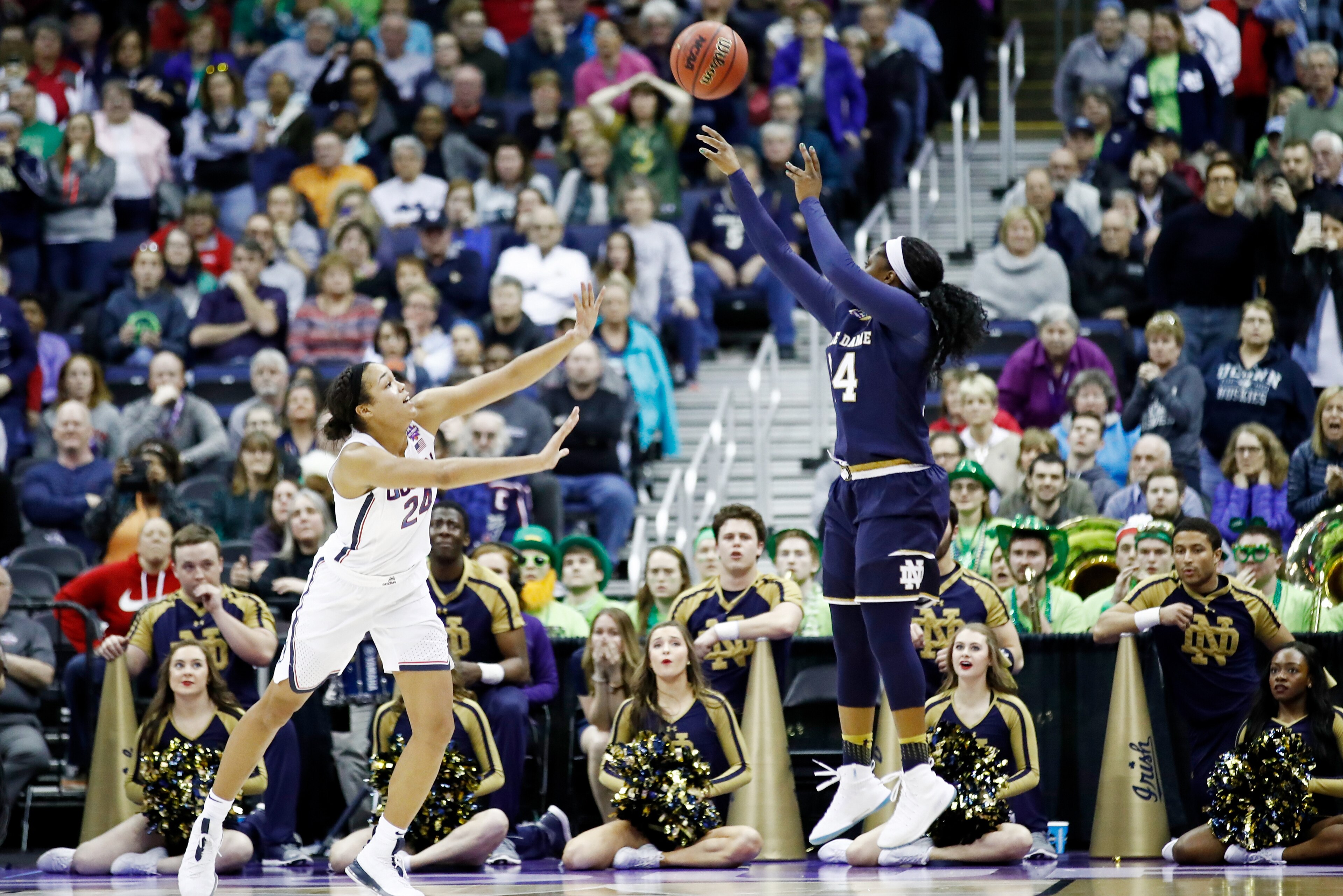 COLUMBUS, OH - MARCH 30: Arike Ogunbowale #24 of the Notre Dame Fighting Irish hits the game winning shot with 1 second left in overtime under pressure from Napheesa Collier #24 of the Connecticut Huskies in the semifinals of the 2018 NCAA Women's Final F