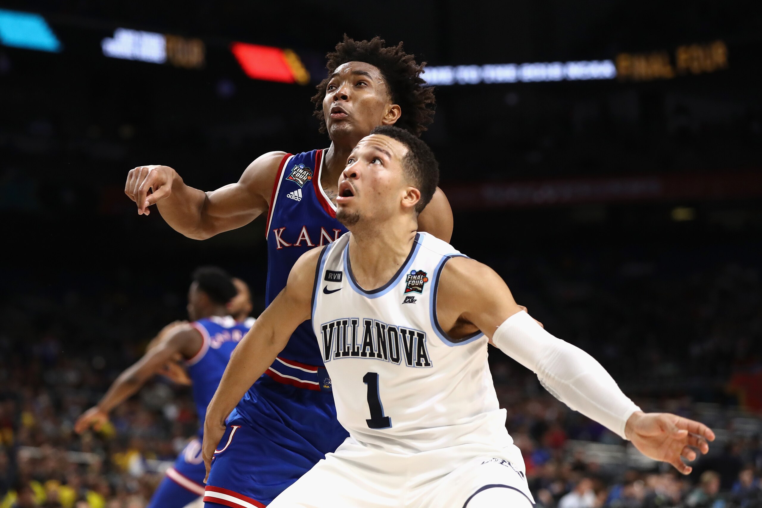 SAN ANTONIO, TX - MARCH 31:  Devonte' Graham #4 of the Kansas Jayhawks competes for position with Jalen Brunson #1 of the Villanova Wildcats in the second half during the 2018 NCAA Men's Final Four Semifinal at the Alamodome on March 31, 2018 in San Anton