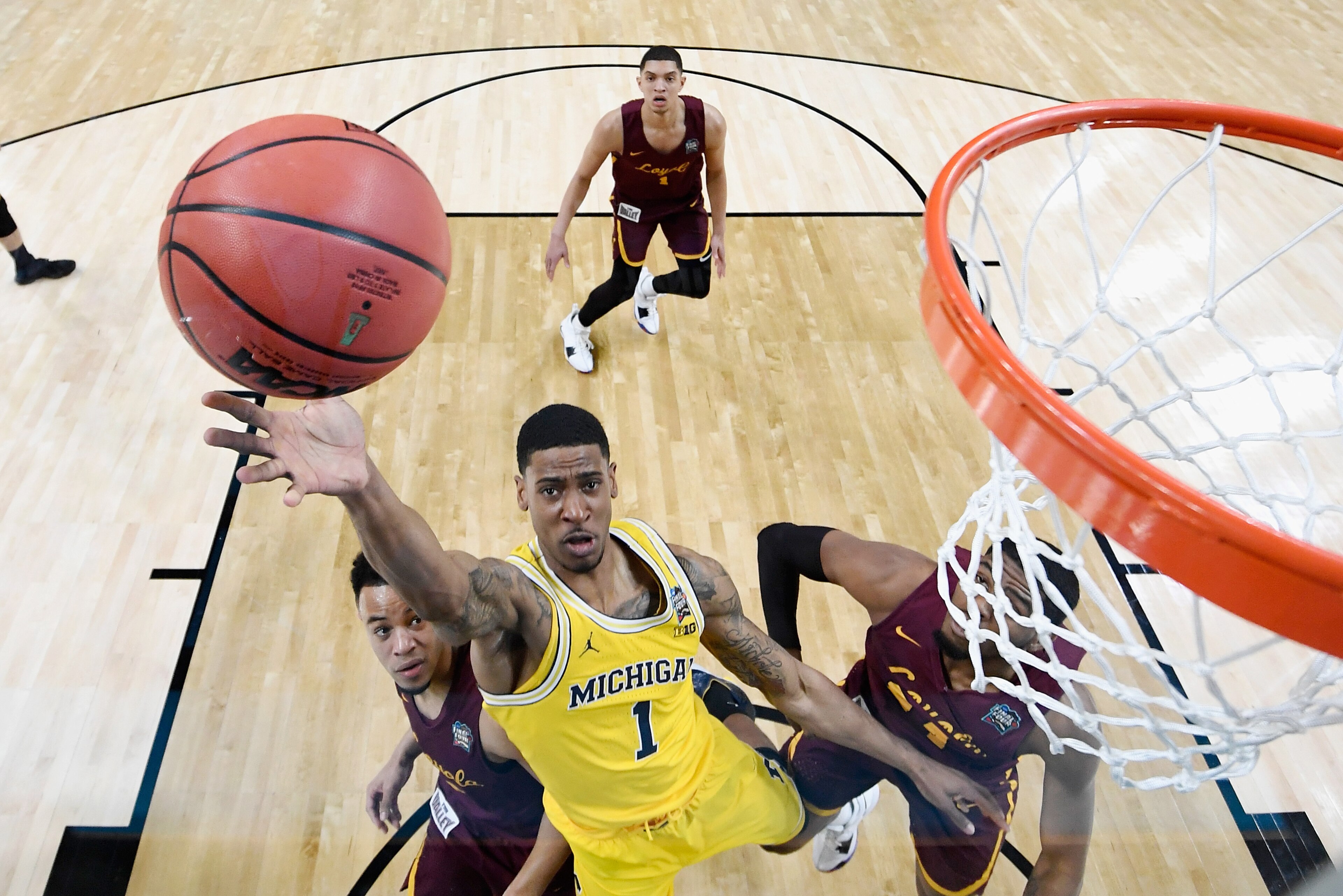 SAN ANTONIO, TX - MARCH 31: Charles Matthews #1 of the Michigan Wolverines drives to the basket against Marques Townes #5 of the Loyola Ramblers in the first half in the 2018 NCAA Men's Final Four semifinal game at the Alamodome on March 31, 2018 in San A