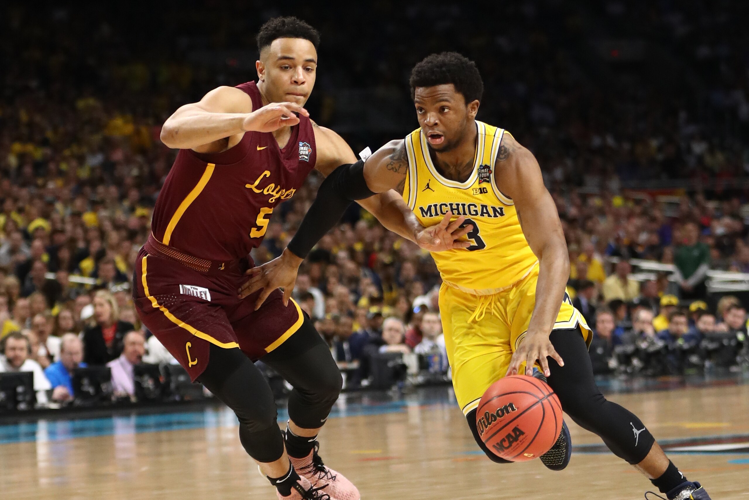 SAN ANTONIO, TX - MARCH 31: Zavier Simpson #3 of the Michigan Wolverines is defended by Marques Townes #5 of the Loyola Ramblers in the first half during the 2018 NCAA Men's Final Four Semifinal at the Alamodome on March 31, 2018 in San Antonio, Texas.  (