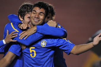 Brazil's half-back Casemiro (C) is congratulated by teammates after scoring the opening goal in the match against Colombia during their second-round match of the Under-20 South American championship, plays at the UNPA Stadium in Arequipa, 1,000 km south o