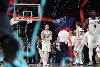 SAN ANTONIO, TX - APRIL 02: Donte DiVincenzo #10 of the Villanova Wildcats celebrates with teammates as confetti falls after defeating the Michigan Wolverines during the 2018 NCAA Men's Final Four National Championship game at the Alamodome on April 2, 20