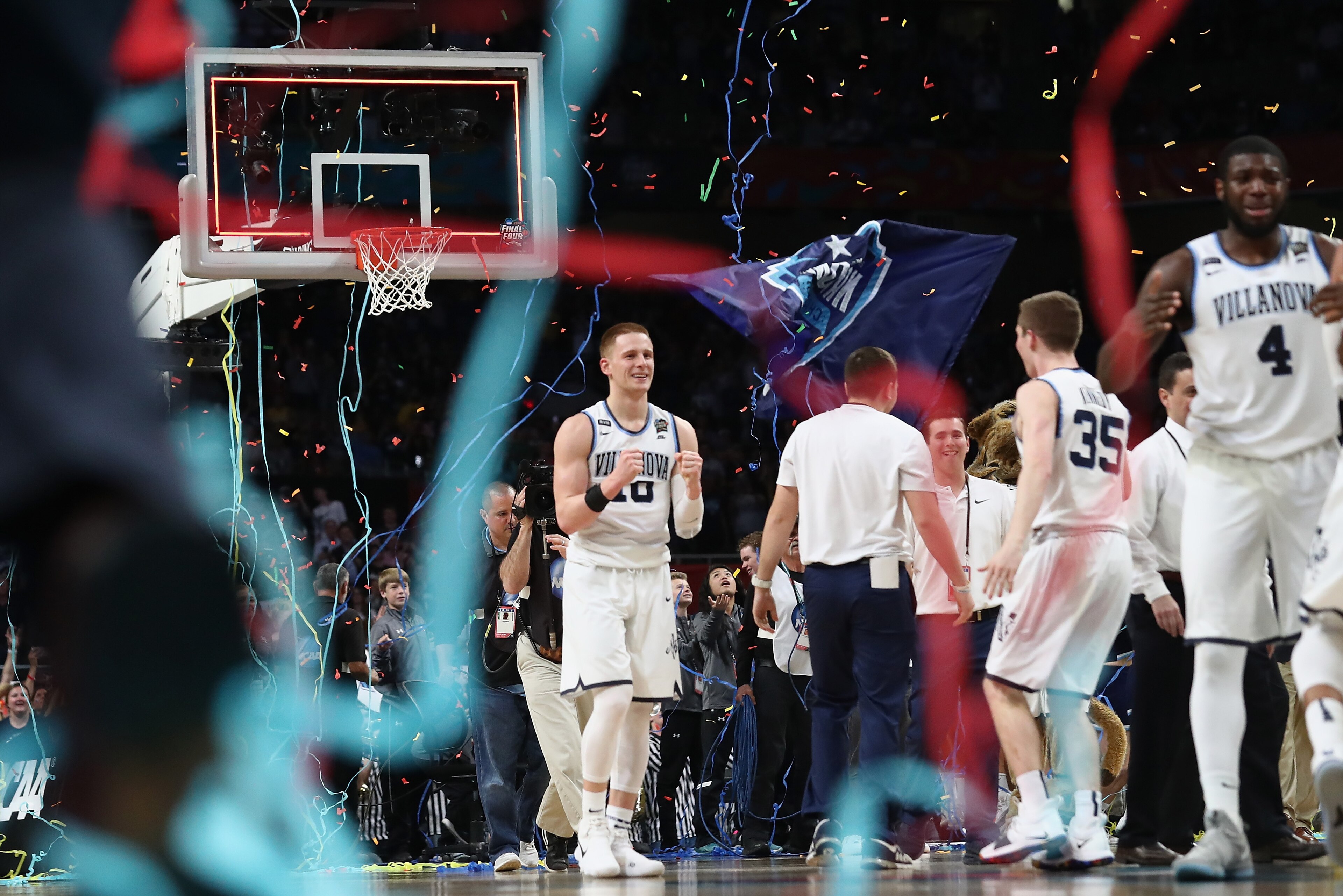 SAN ANTONIO, TX - APRIL 02: Donte DiVincenzo #10 of the Villanova Wildcats celebrates with teammates as confetti falls after defeating the Michigan Wolverines during the 2018 NCAA Men's Final Four National Championship game at the Alamodome on April 2, 20