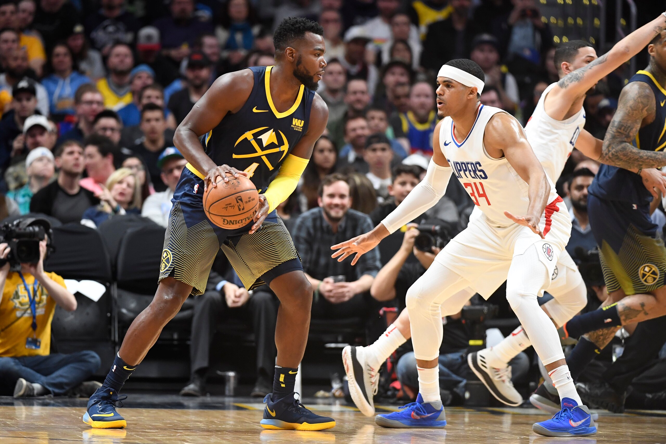 DENVER, CO - FEBRUARY 27: Paul Millsap #4 of the Denver Nuggets is guarded by Tobias Harris #34 of the LA Clippers at Pepsi Center on February 27, 2018 in Denver, Colorado. NOTE TO USER: User expressly acknowledges and agrees that, by downloading and or u