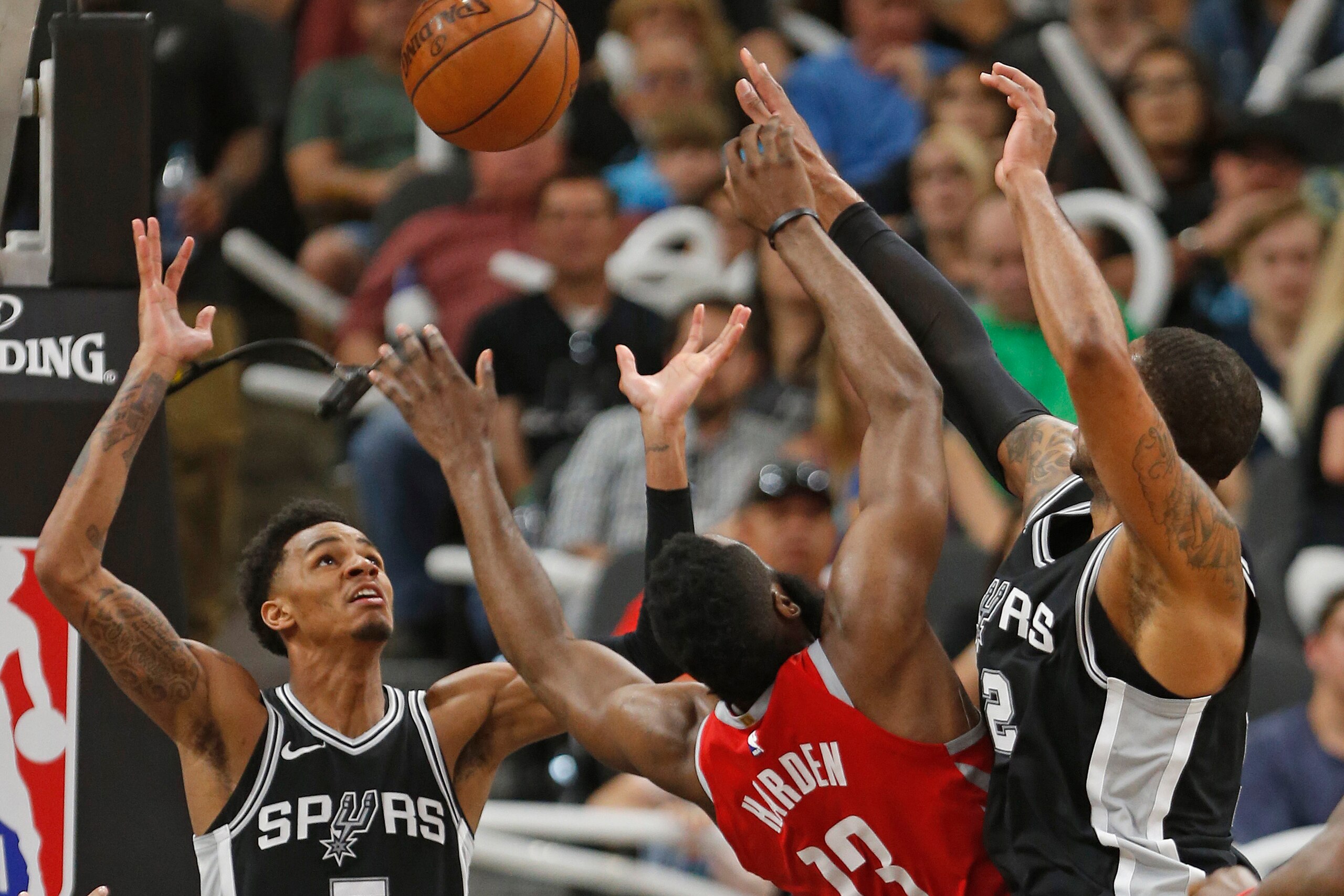 SAN ANTONIO,TX - APRIL 1 : Dejounte Murray #5 of the San Antonio Spurs gathers in the ball after LaMarcus Aldridge #12 of the San Antonio Spurs blocked shot of James Harden #13 of the Houston Rockets at AT&T Center on April 1 , 2018 in San Antonio, Texas.