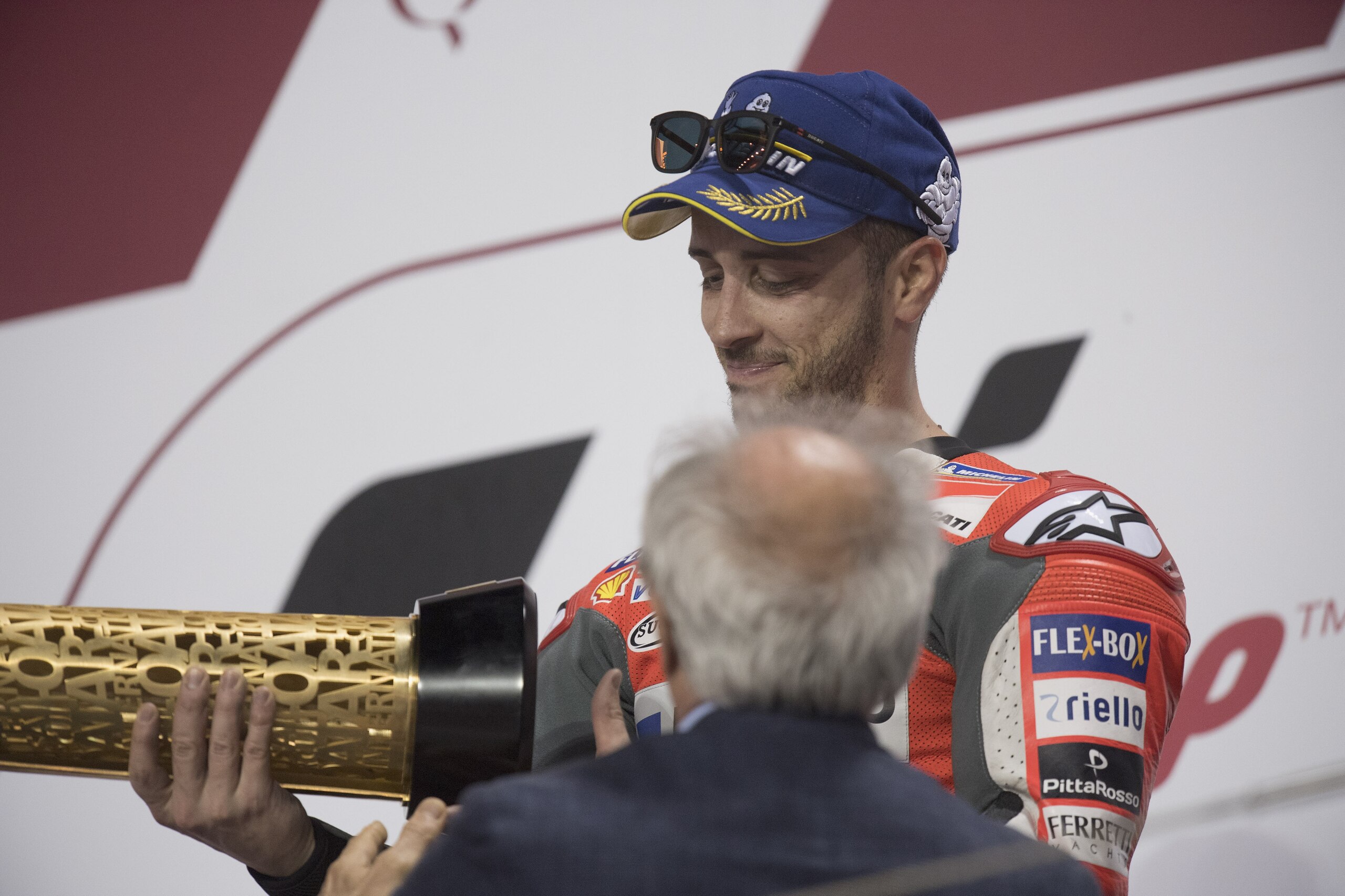 DOHA, QATAR - MARCH 18:  Andrea Dovizioso of Italy and Ducati Team celebrates the victory on the podium at the end of the MotoGP race during the MotoGP of Qatar - Race at Losail Circuit on March 18, 2018 in Doha, Qatar.  (Photo by Mirco Lazzari gp/Getty I