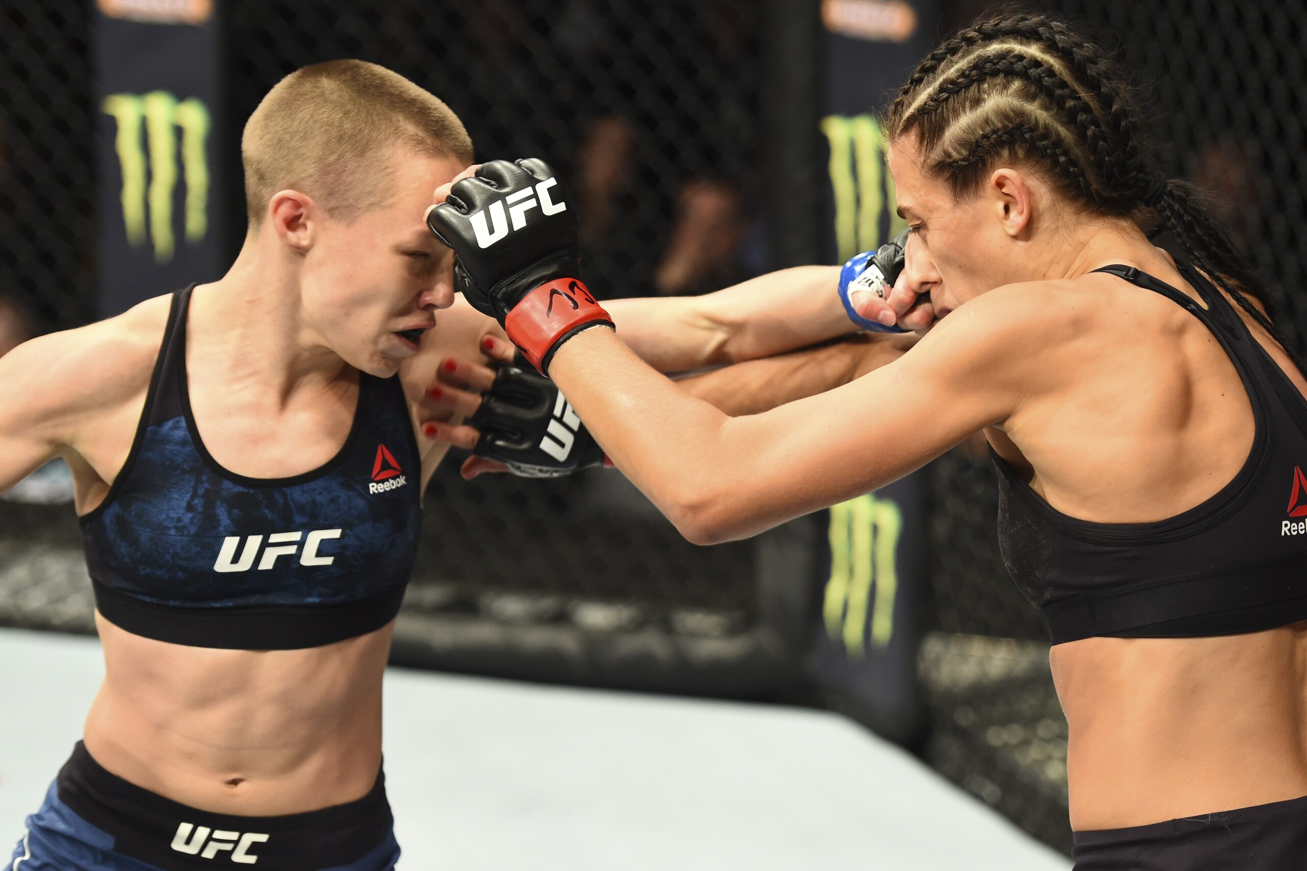 NEW YORK, NY - NOVEMBER 04:  (L-R) Rose Namajunas punches Joanna Jedrzejczyk of Poland in their UFC women's strawweight championship bout during the UFC 217 event inside Madison Square Garden on November 4, 2017 in New York City. (Photo by Josh Hedges/Zuf