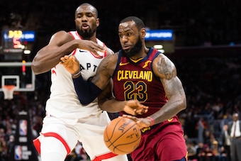 CLEVELAND, OH - MARCH 21: Serge Ibaka #9 of the Toronto Raptors tries to guard LeBron James #23 of the Cleveland Cavaliers during the second half at Quicken Loans Arena on March 21, 2018 in Cleveland, Ohio. The Cavaliers defeated the Raptors 132-129. NOTE