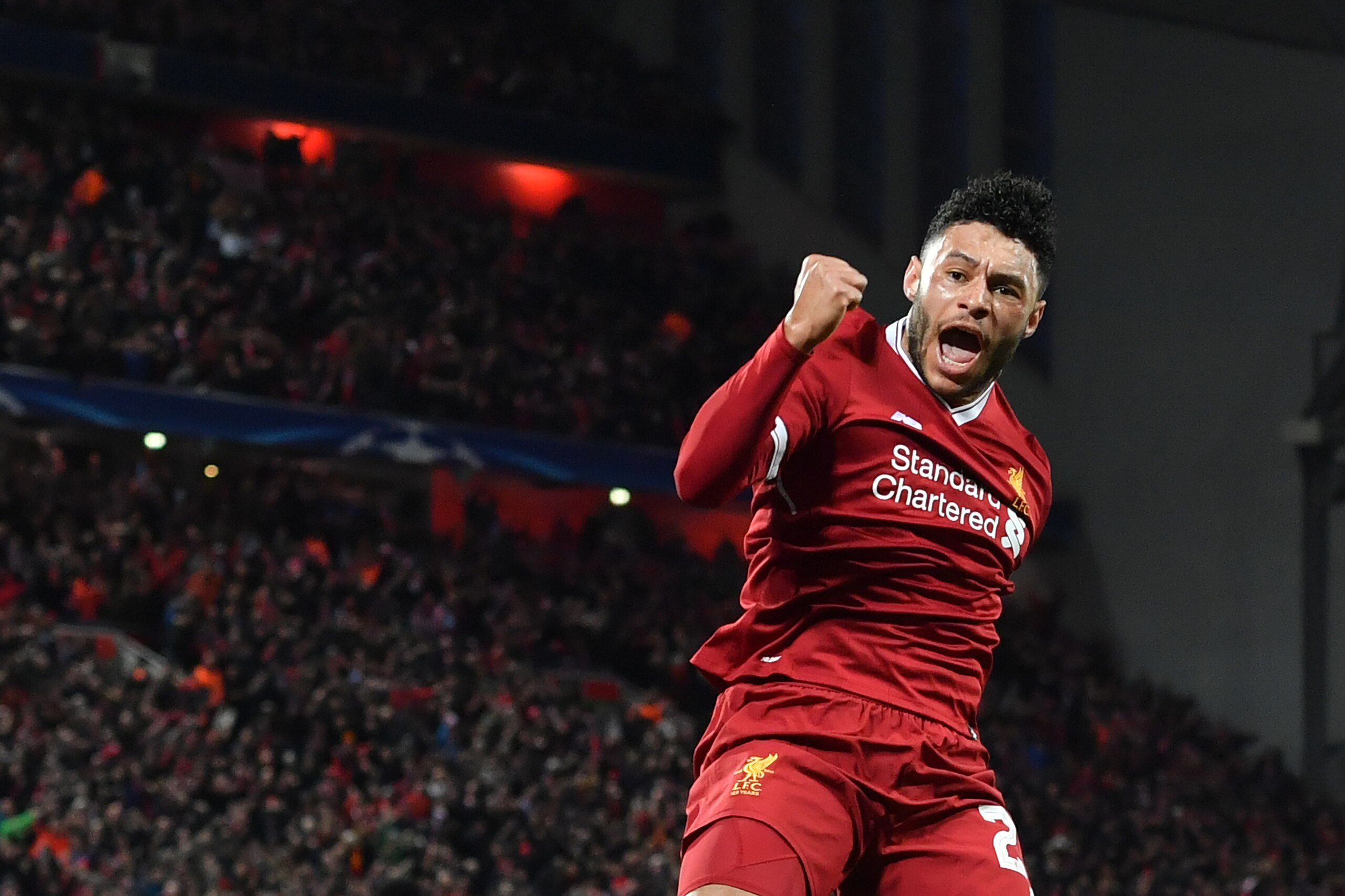 Liverpool's English midfielder Alex Oxlade-Chamberlain celebrates scoring the team's second goal during the UEFA Champions League first leg quarter-final football match between Liverpool and Manchester City, at Anfield stadium in Liverpool, north west Eng