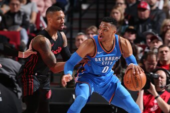 PORTLAND, OR - MARCH 3: Russell Westbrook #0 of the Oklahoma City Thunder handles the ball against Damian Lillard #0 of the Portland Trail Blazers on March 3, 2018 at the Moda Center in Portland, Oregon. NOTE TO USER: User expressly acknowledges and agree