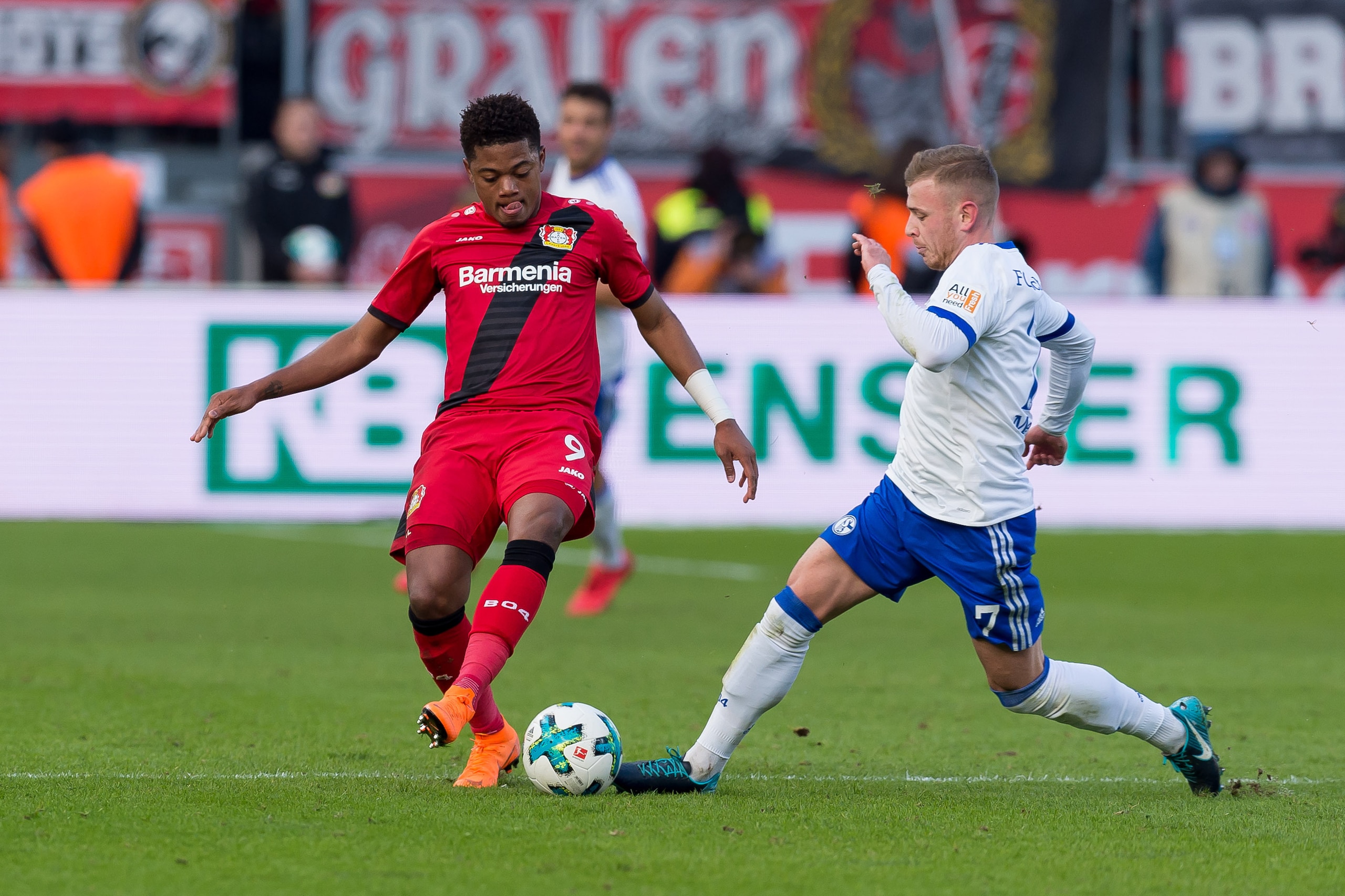 LEVERKUSEN, GERMANY - FEBRUARY 25: Leon Bailey of Leverkusen and Max Meyer of Schalke battle for the ball during the Bundesliga match between Bayer 04 Leverkusen and FC Schalke 04 at BayArena on February 25, 2018 in Leverkusen, Germany. (Photo by TF-Image