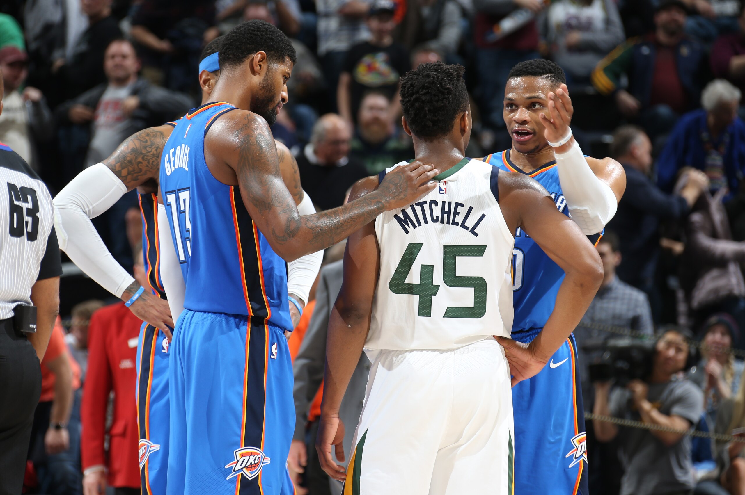SALT LAKE CITY, UT - DECEMBER 23: Donovan Mitchell #45 of the Utah Jazz talks with Russell Westbrook #0, Carmelo Anthony #7, and Paul George #13 of the Oklahoma City Thunder after the game on December 23, 2017 at vivint.SmartHome Arena in Salt Lake City, 