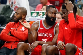 SAN ANTONIO,TX - APRIL 1 :  James Harden #13 of the Houston Rockets talks with teammate Clint Capela #15 of the Houston Rockets while Chris Paul #3 of the Houston Rockets,L watches the game at AT&T Center on April 1 , 2018  in San Antonio, Texas.  NOTE TO