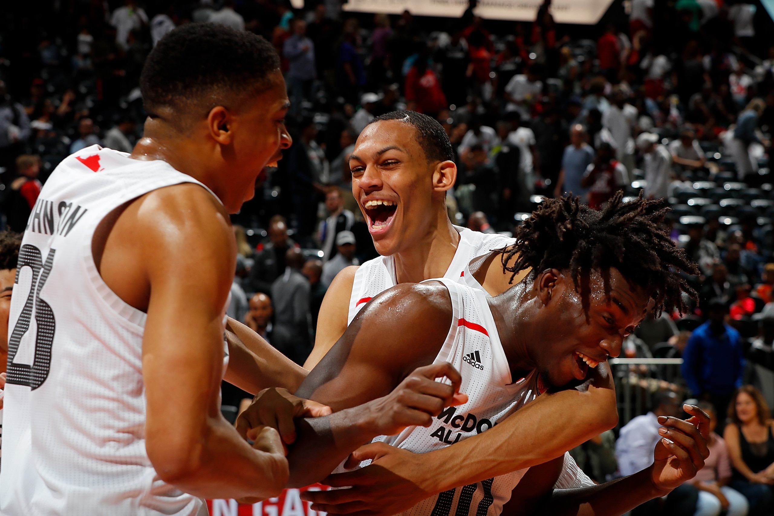 ATLANTA, GA - MARCH 28:  Nassir Little #10 of Orlando Christian Prep is congratulated by teammates Keldon Johnson #23 of Oak Hill Academy and Darius Bazley #15 of Princeton High School after he won the MVP trophy in the 2018 McDonald's All American Game a