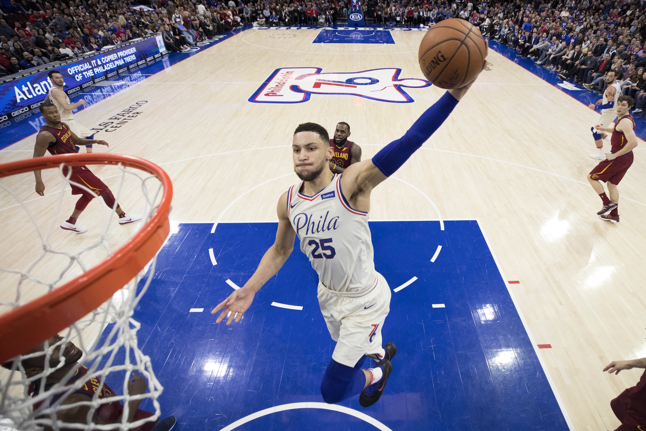 PHILADELPHIA, PA - APRIL 6: Ben Simmons #25 of the Philadelphia 76ers dunks the ball past LeBron James #23 of the Cleveland Cavaliers in the second quarter at the Wells Fargo Center on April 6, 2018 in Philadelphia, Pennsylvania. The 76ers defeated the Ca