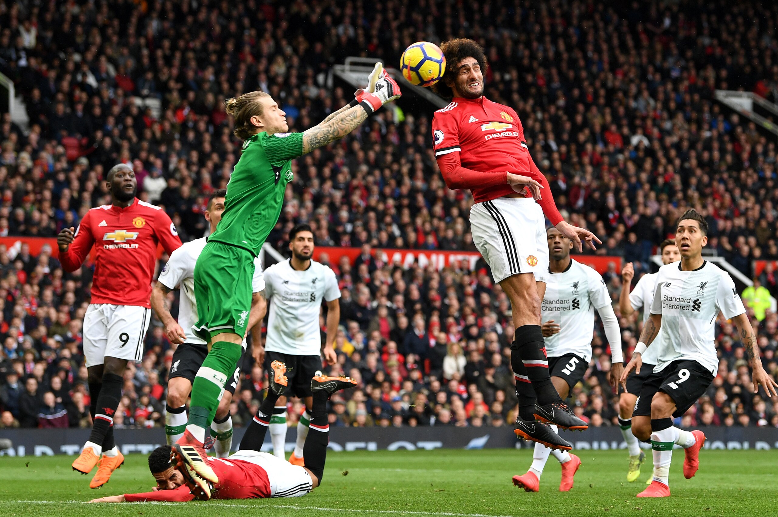 MANCHESTER, ENGLAND - MARCH 10:  Loris Karius of Liverpool competes for the ball with Marouane Fellaini of Manchester United during the Premier League match between Manchester United and Liverpool at Old Trafford on March 10, 2018 in Manchester, England. 